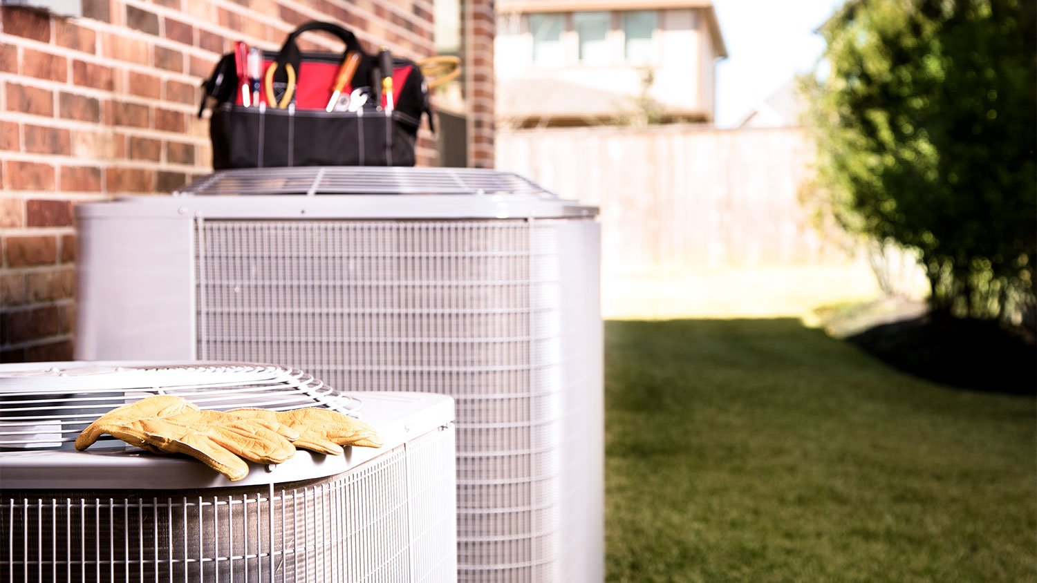 A view of tools on top of an air conditioning unit