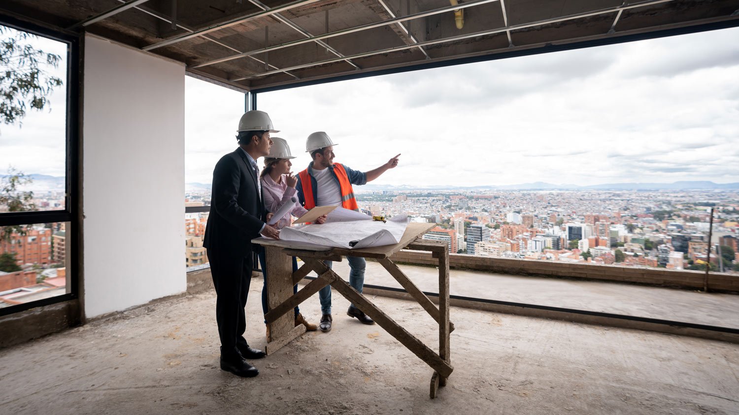 Contractor, architect and engineer working as a team at a construction site