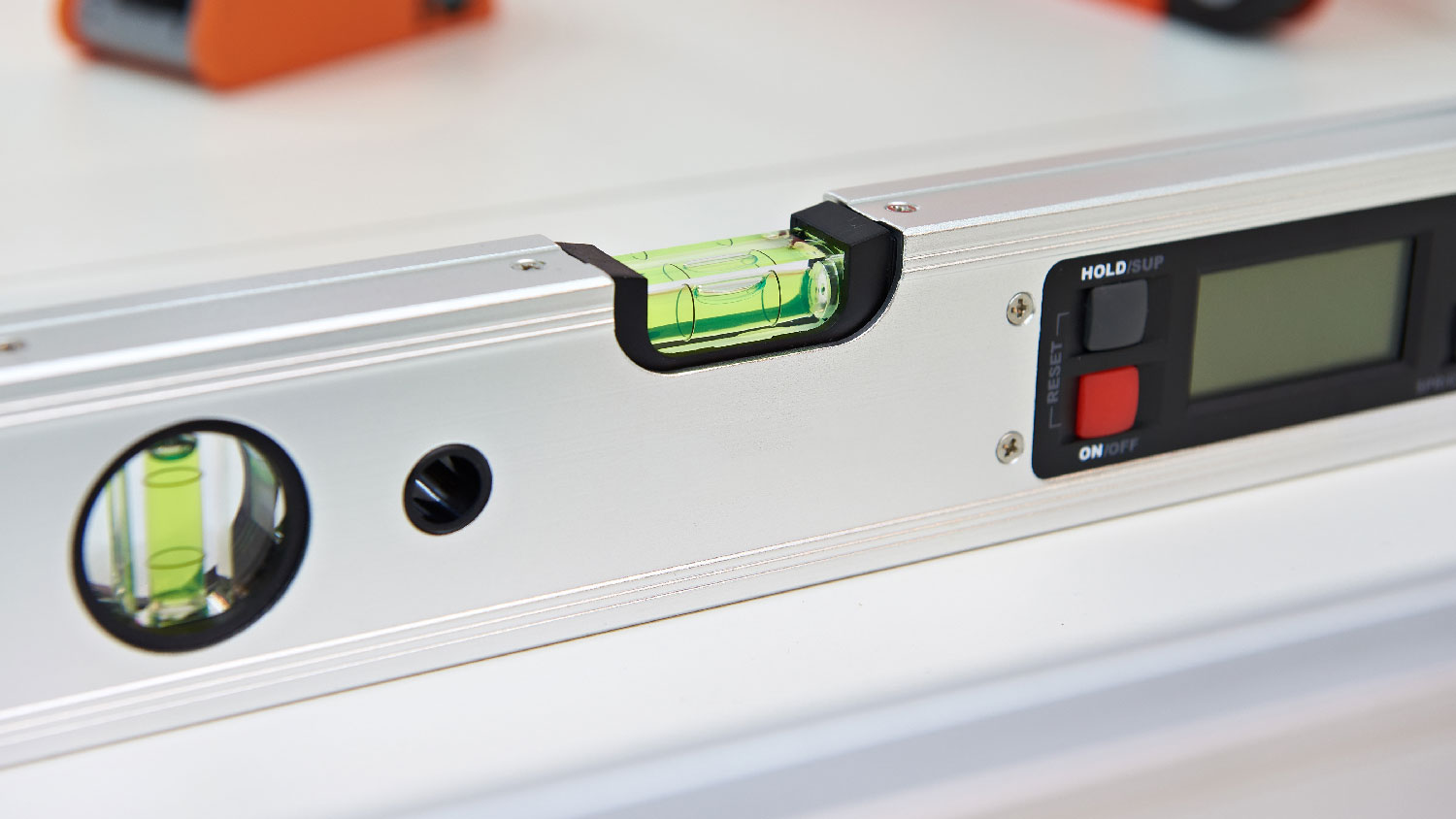 Close-up of a torpedo level on a washing machine