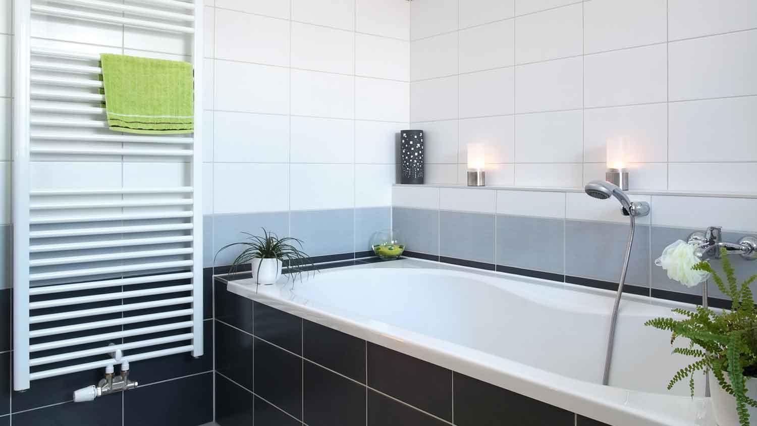 Towel radiator installed next to a bathtub