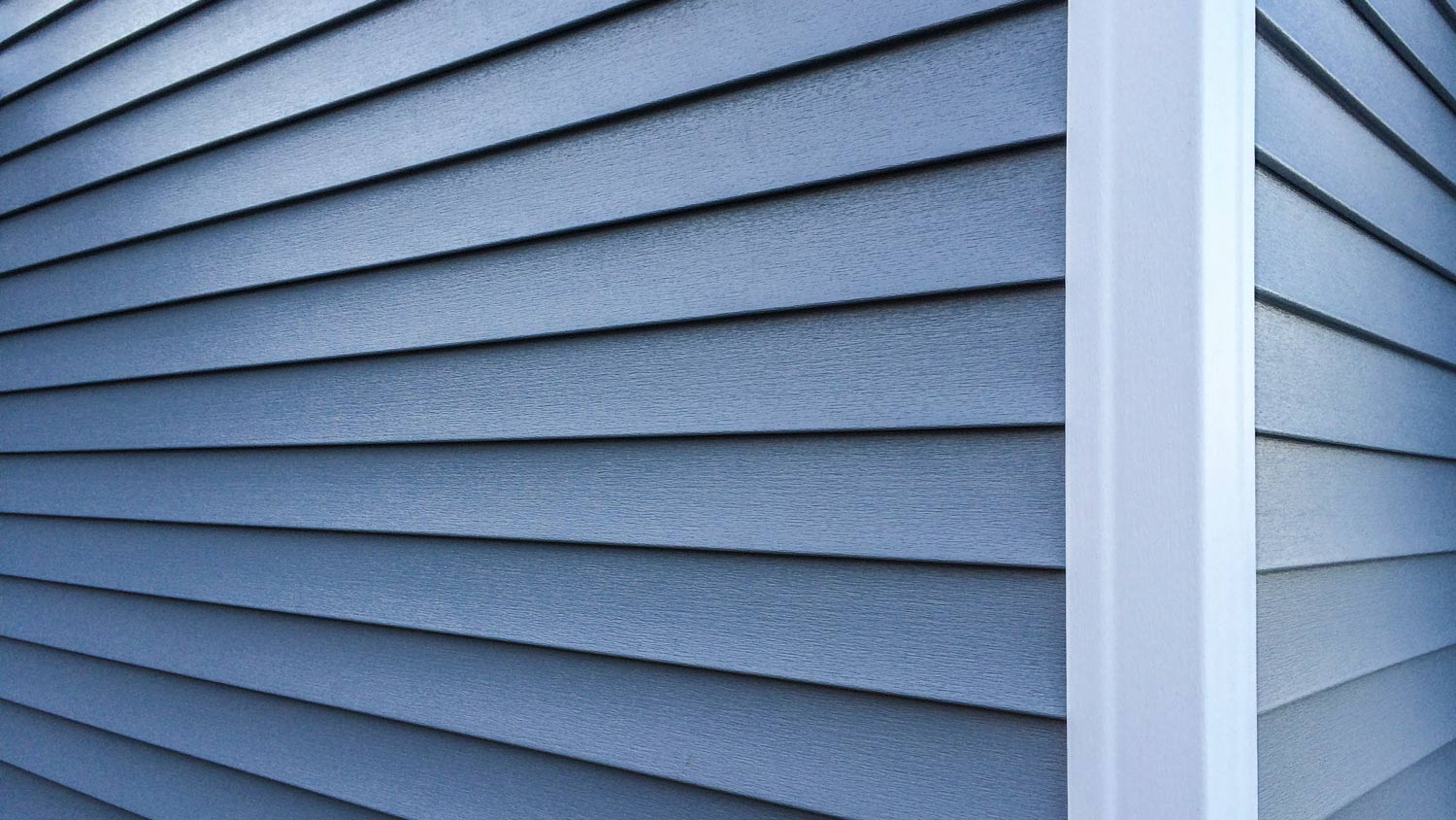 Detail of corner of house with blue siding