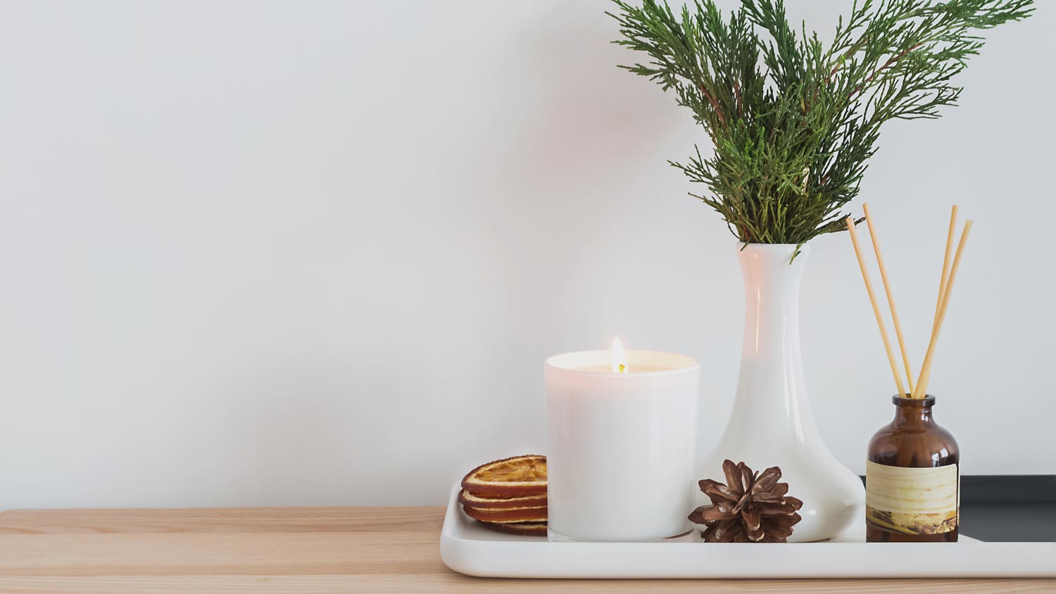 A tray with greenery branch and pinecones