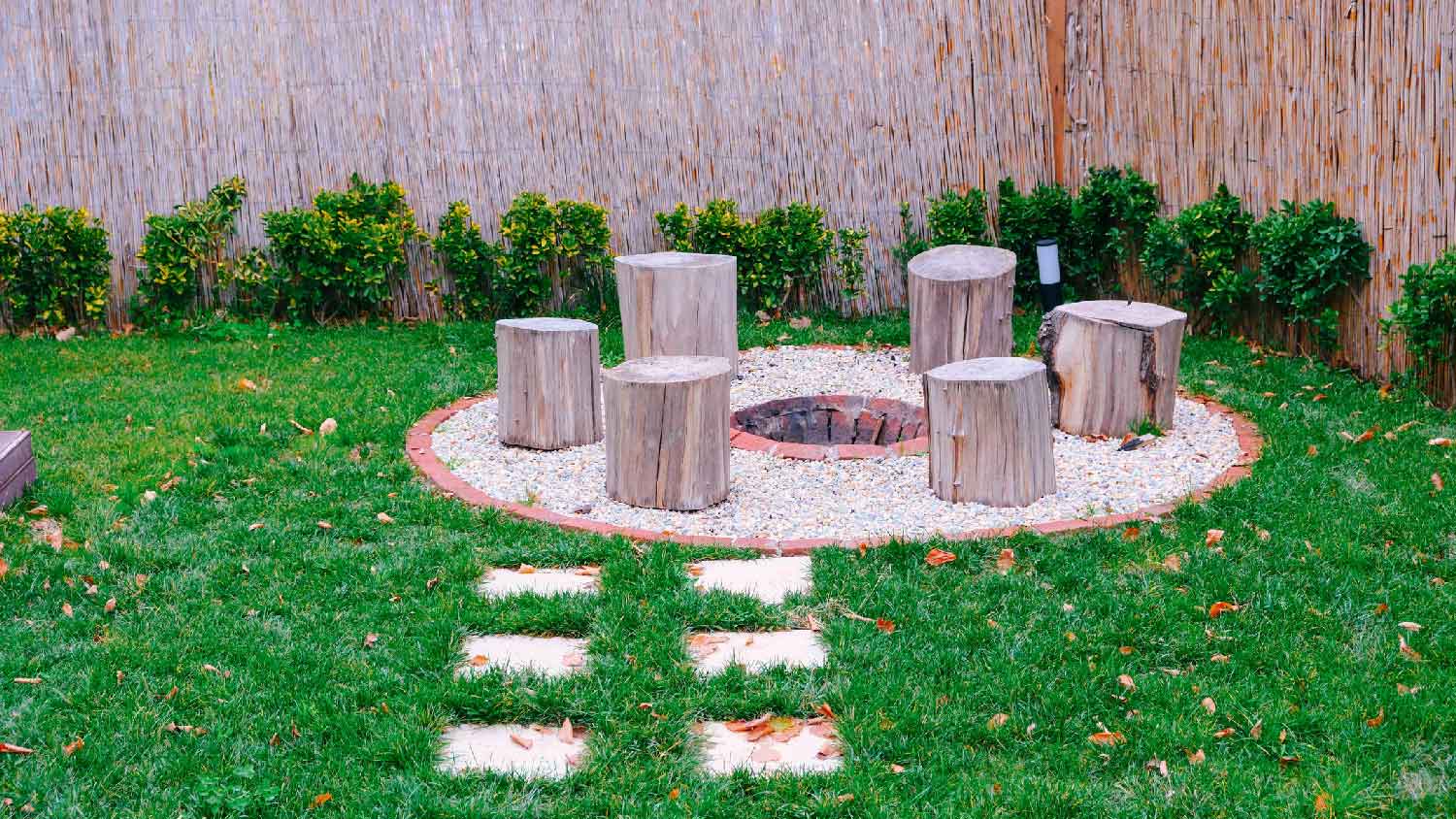 Tree stumps used as seats around a fire pit