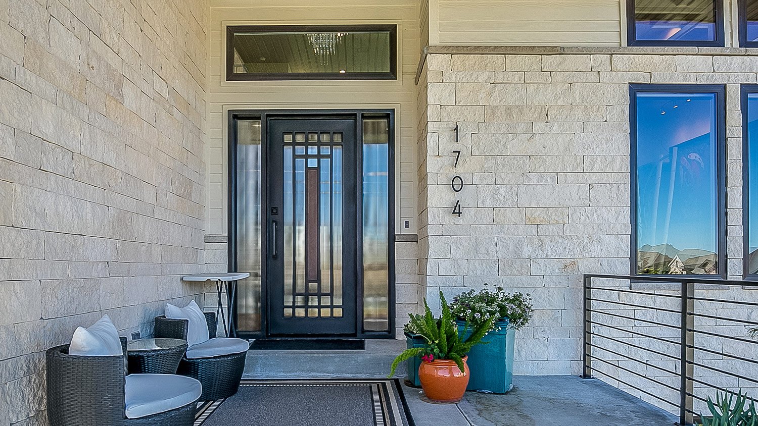 modern home and front yard outdoor patio, vertical house numbers to the side of the front door