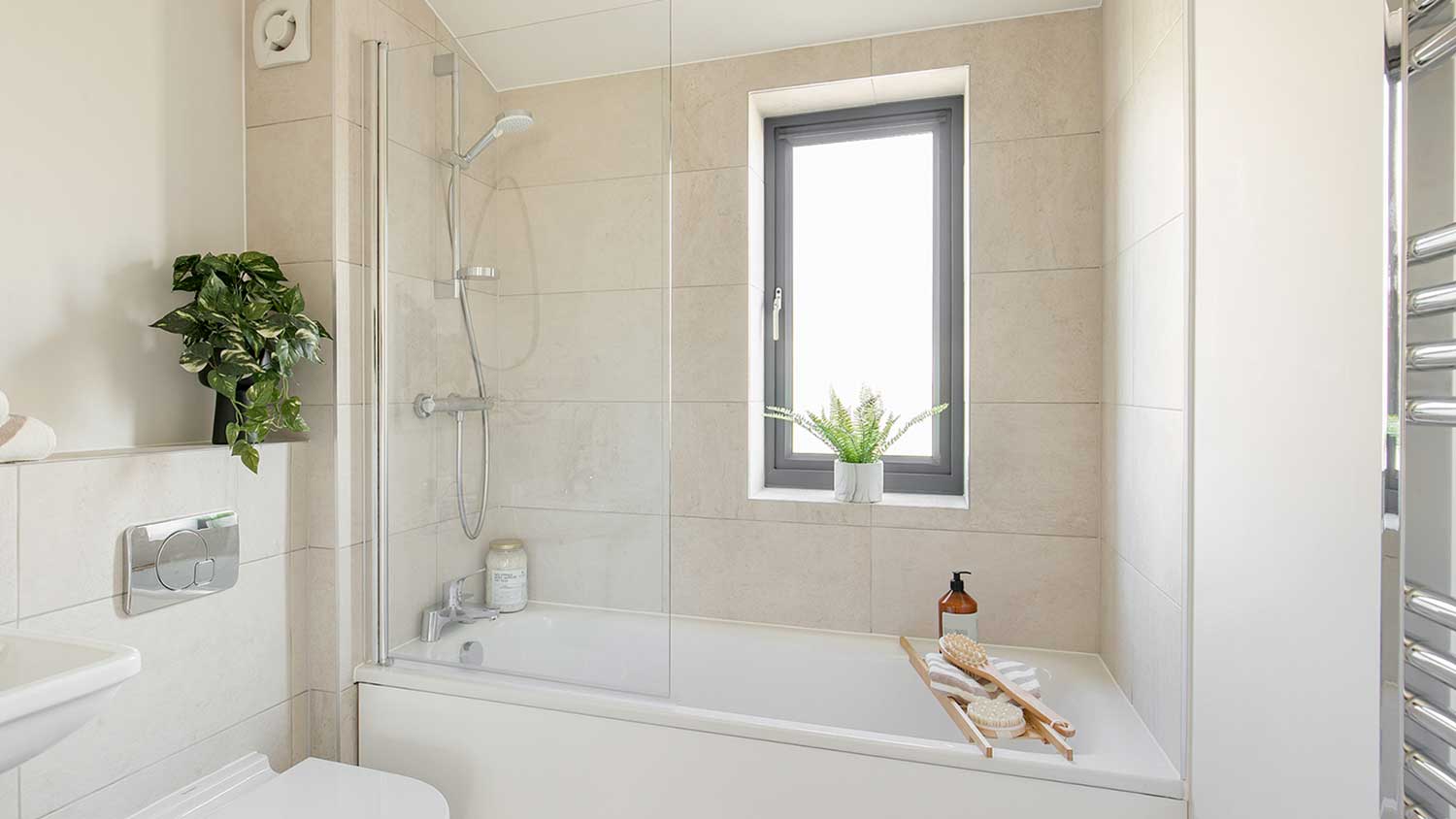 Tub-shower combo installed in a white bathroom