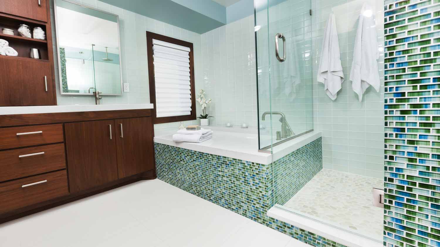 A tub and shower combo in a bathroom with beautiful tiles