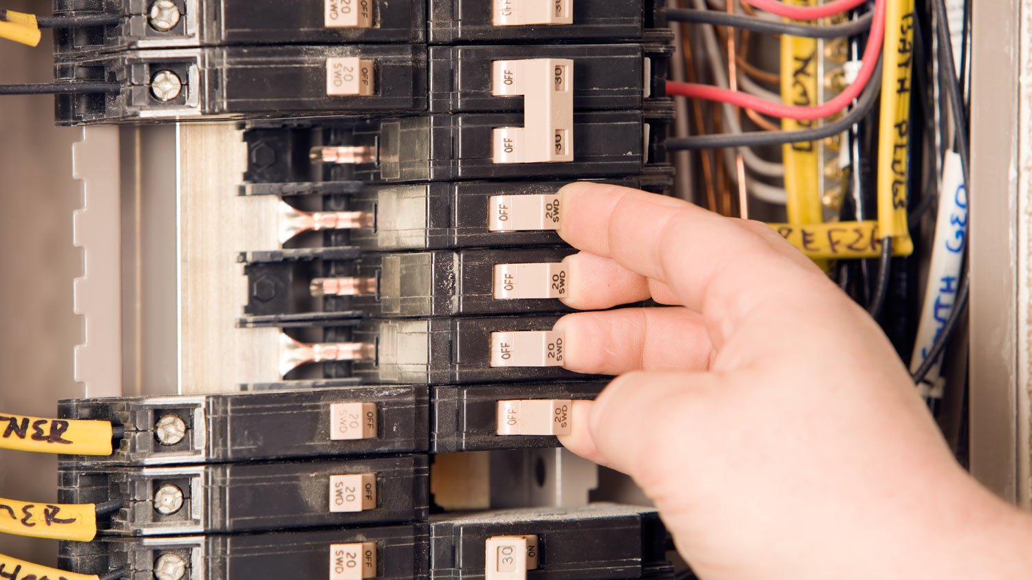 man turning on circuit breakers