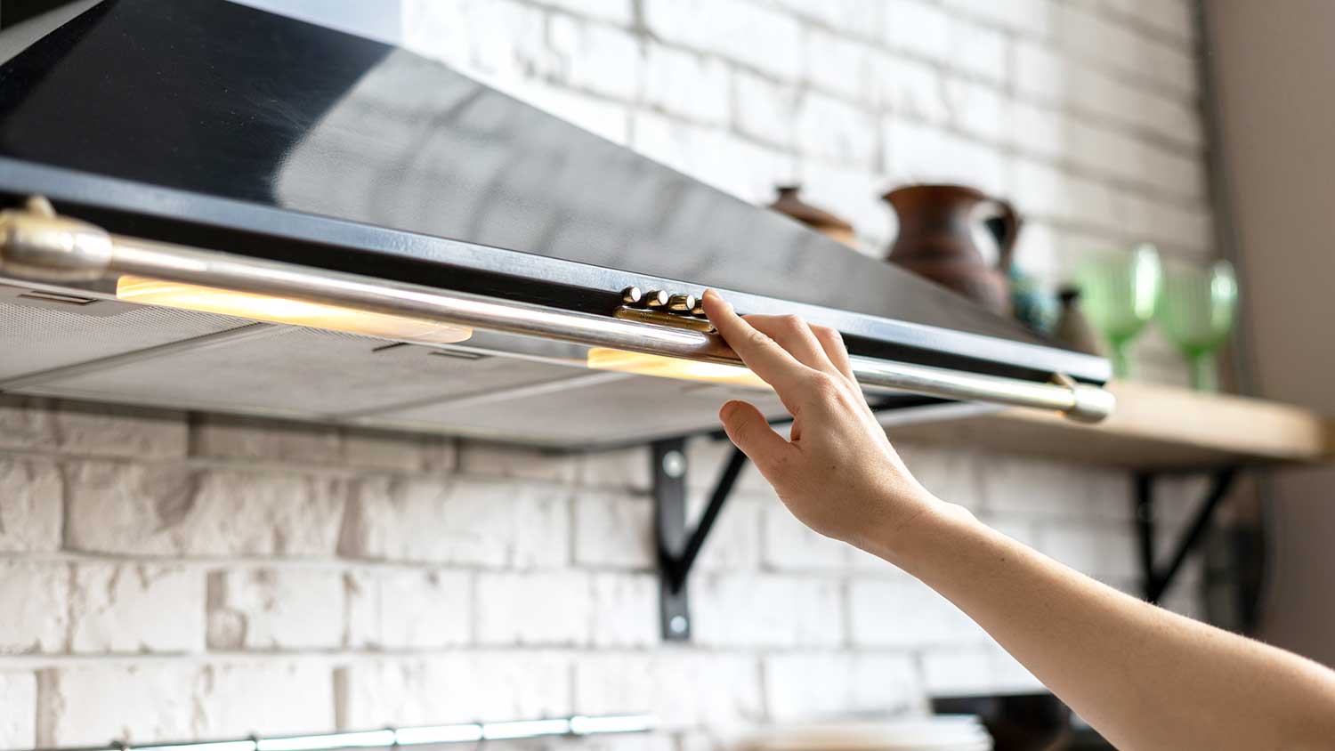 Person using range hood fan when cooking
