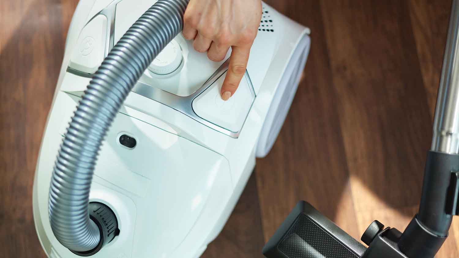 Pressing power button to turn vacuum cleaner on