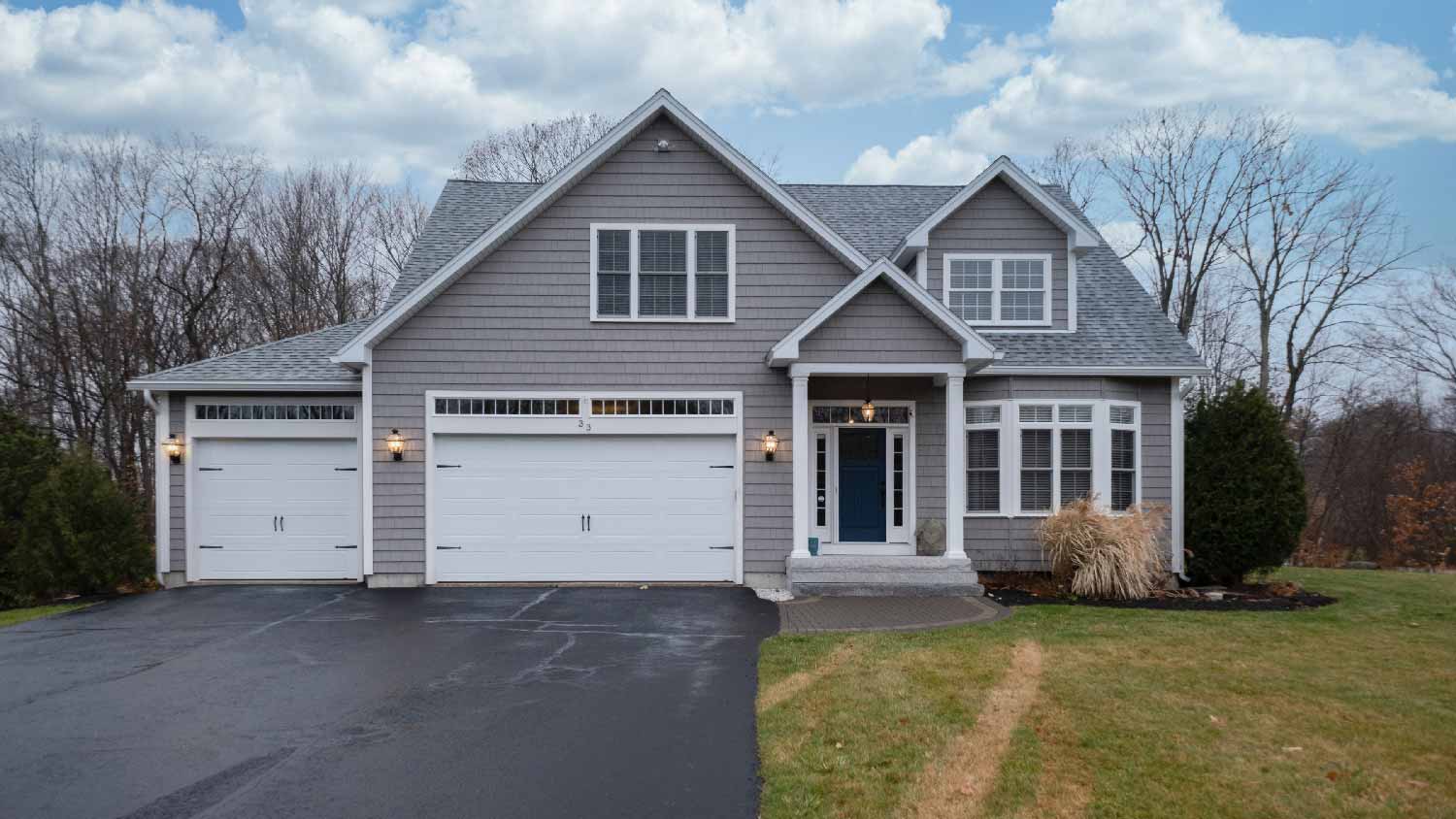 A two story house with gray siding