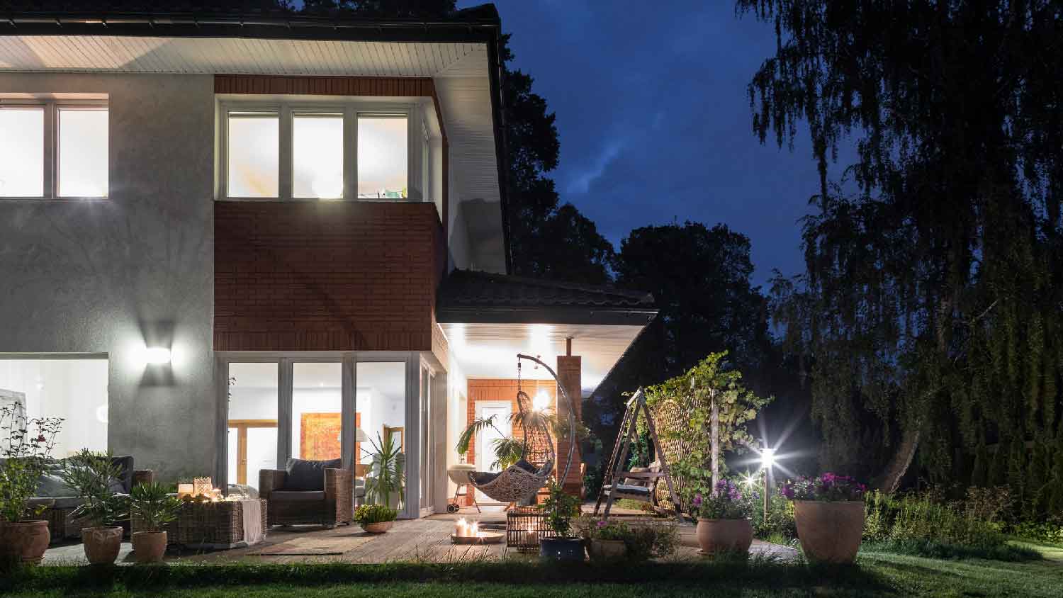 A two story house with outdoor lighting