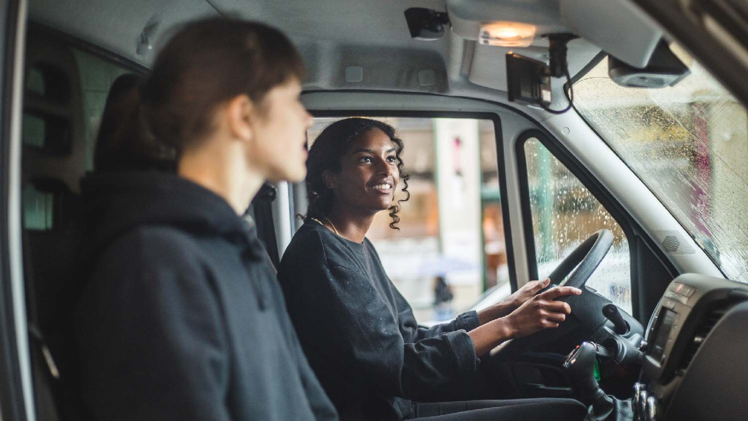 Two women driving truck on moving day