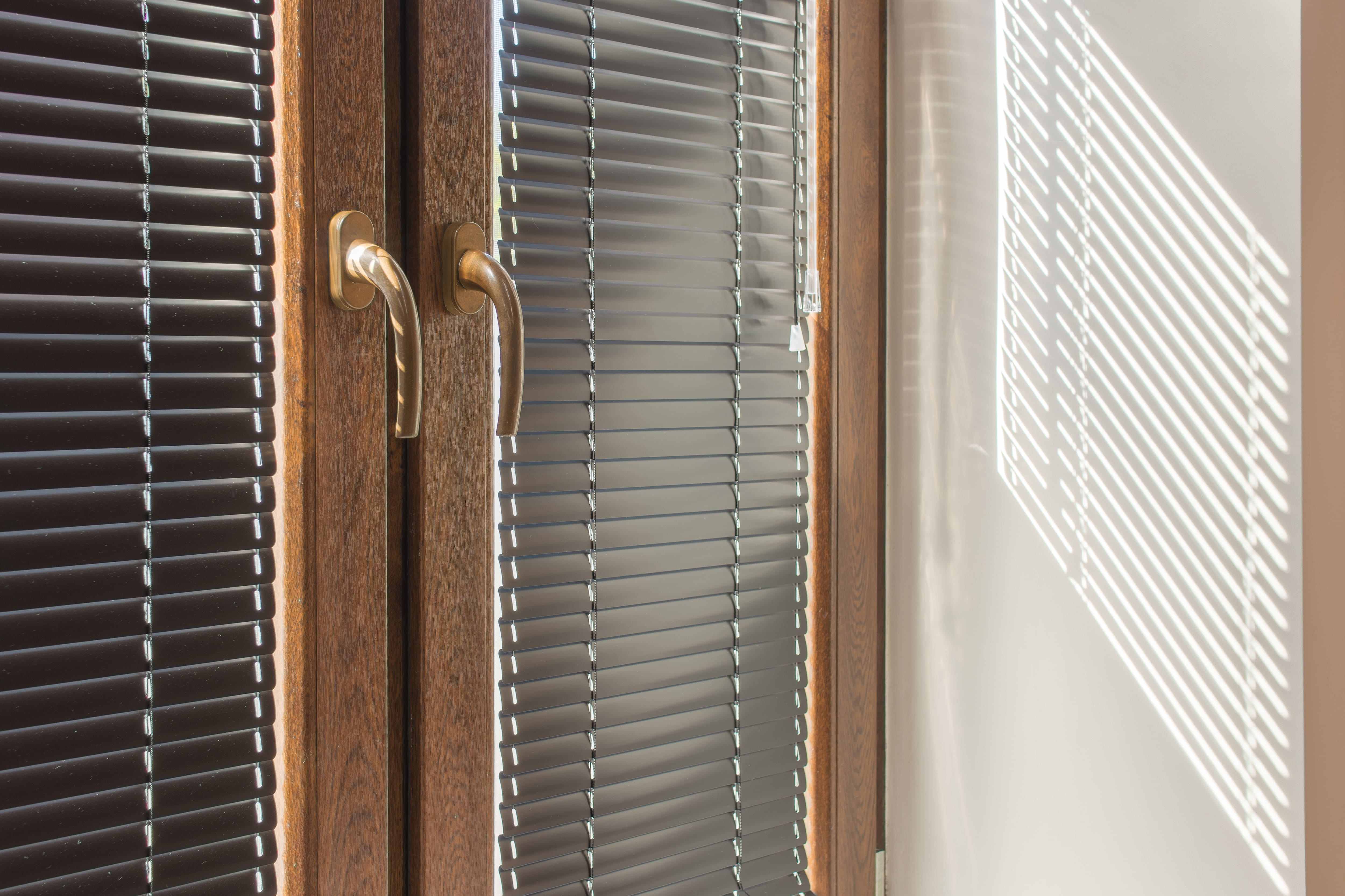 Aluminum blinds hung over patio doors