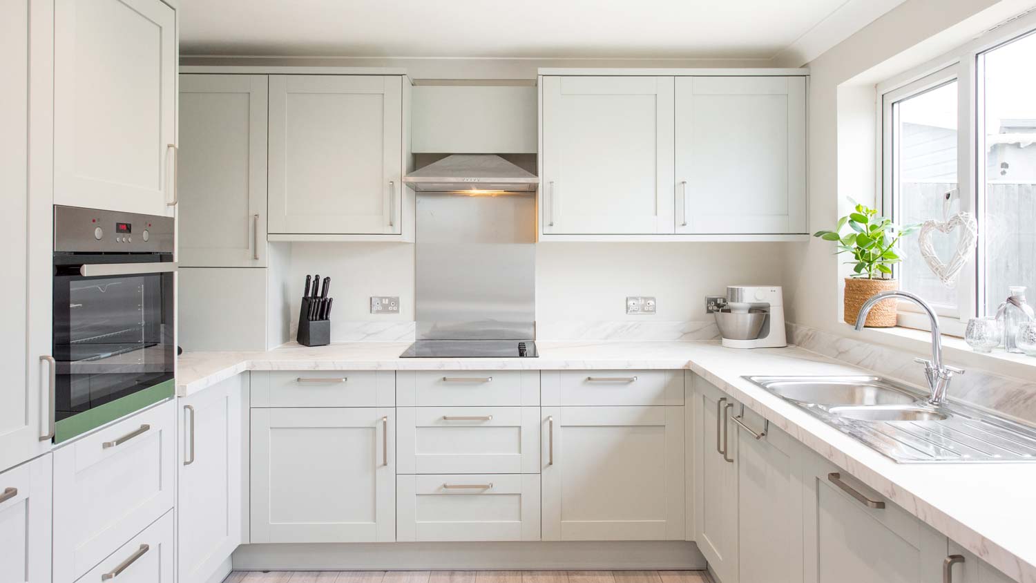 A U-shaped kitchen with white cabinets