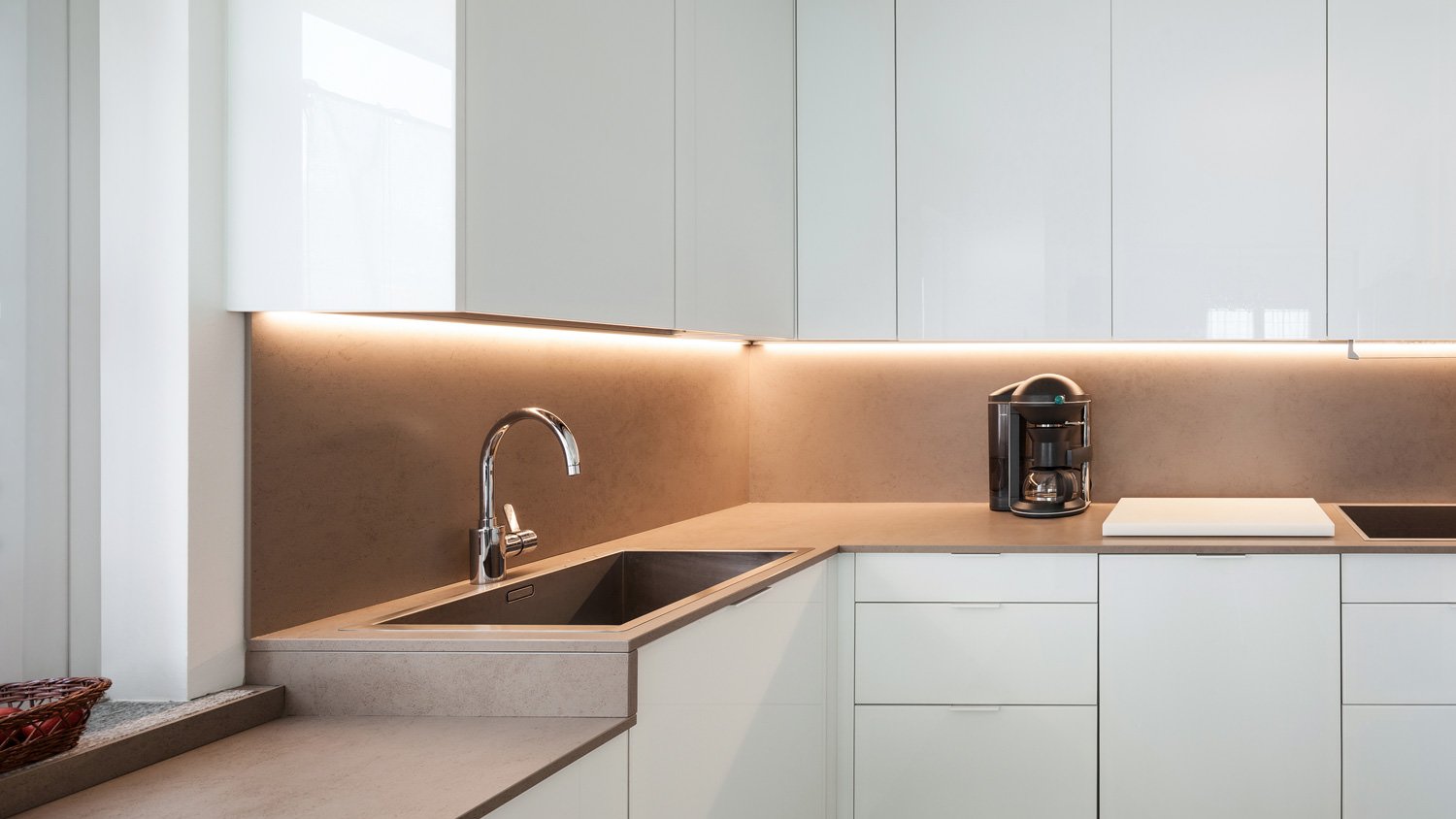 Under cabinet lighting in a modern white kitchen