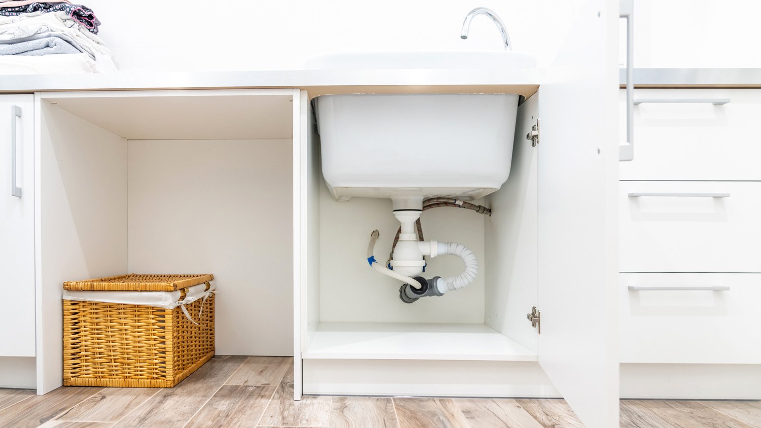 Under the sink view in laundry room