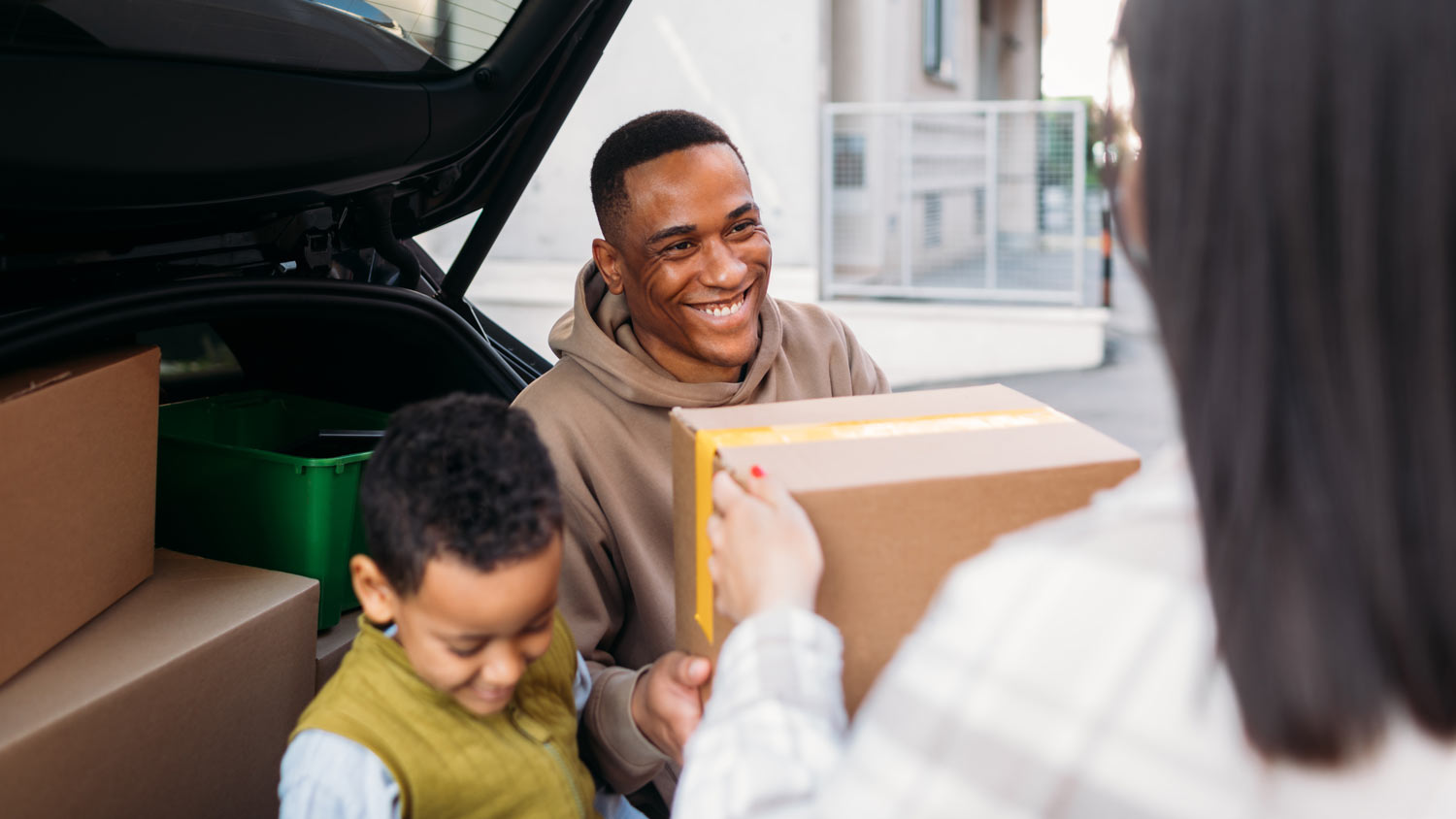 woman passing box to husband