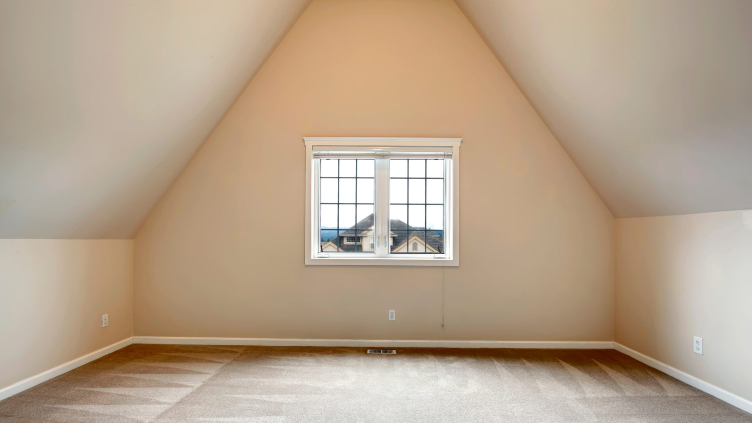 window in empty vaulted ceiling room