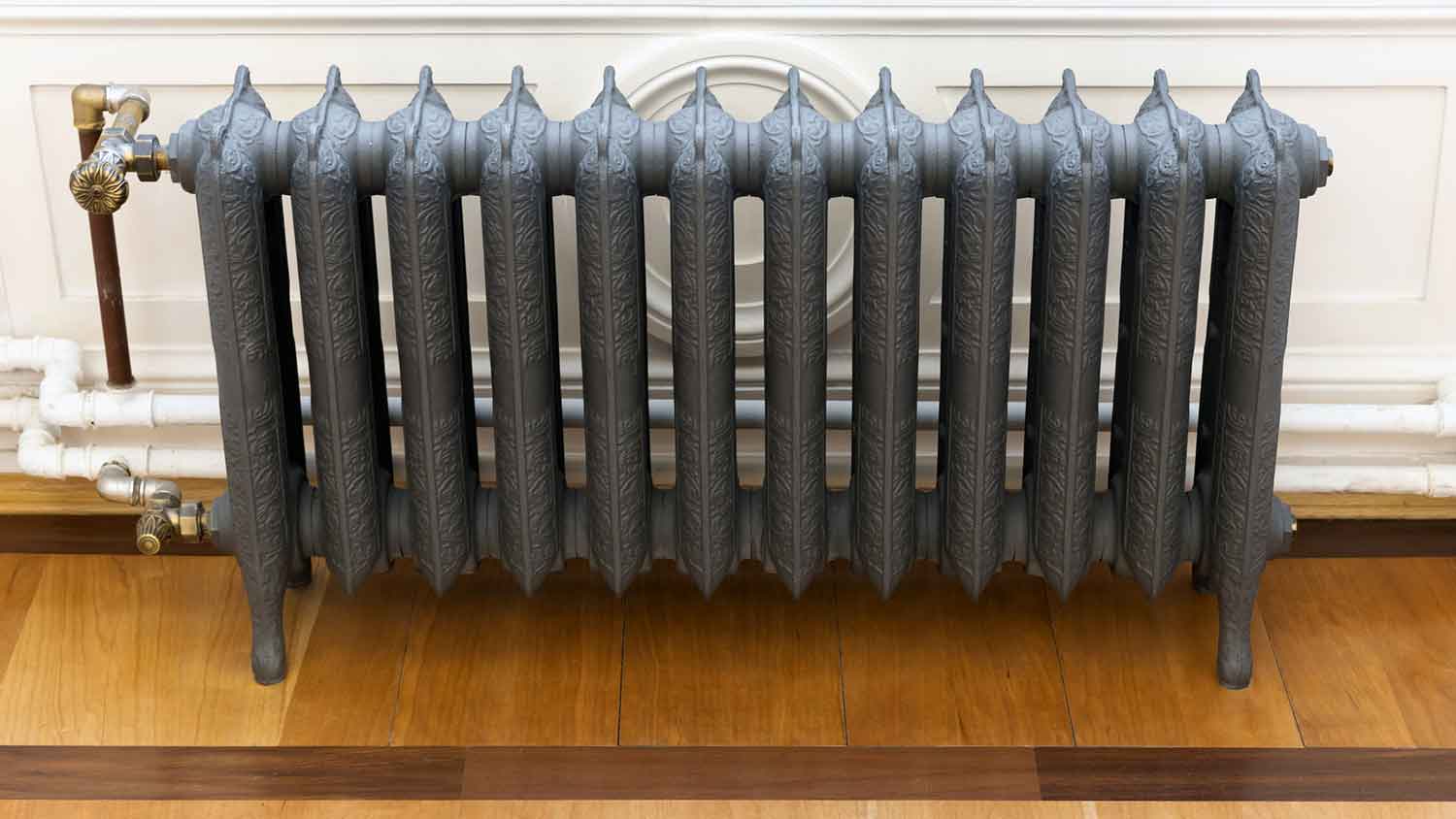 Vintage cast iron radiator with intricate motif