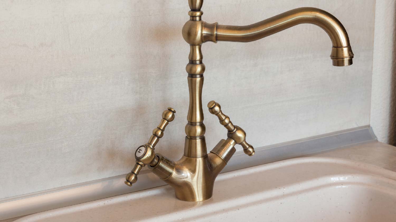 A vintage satin brass faucet