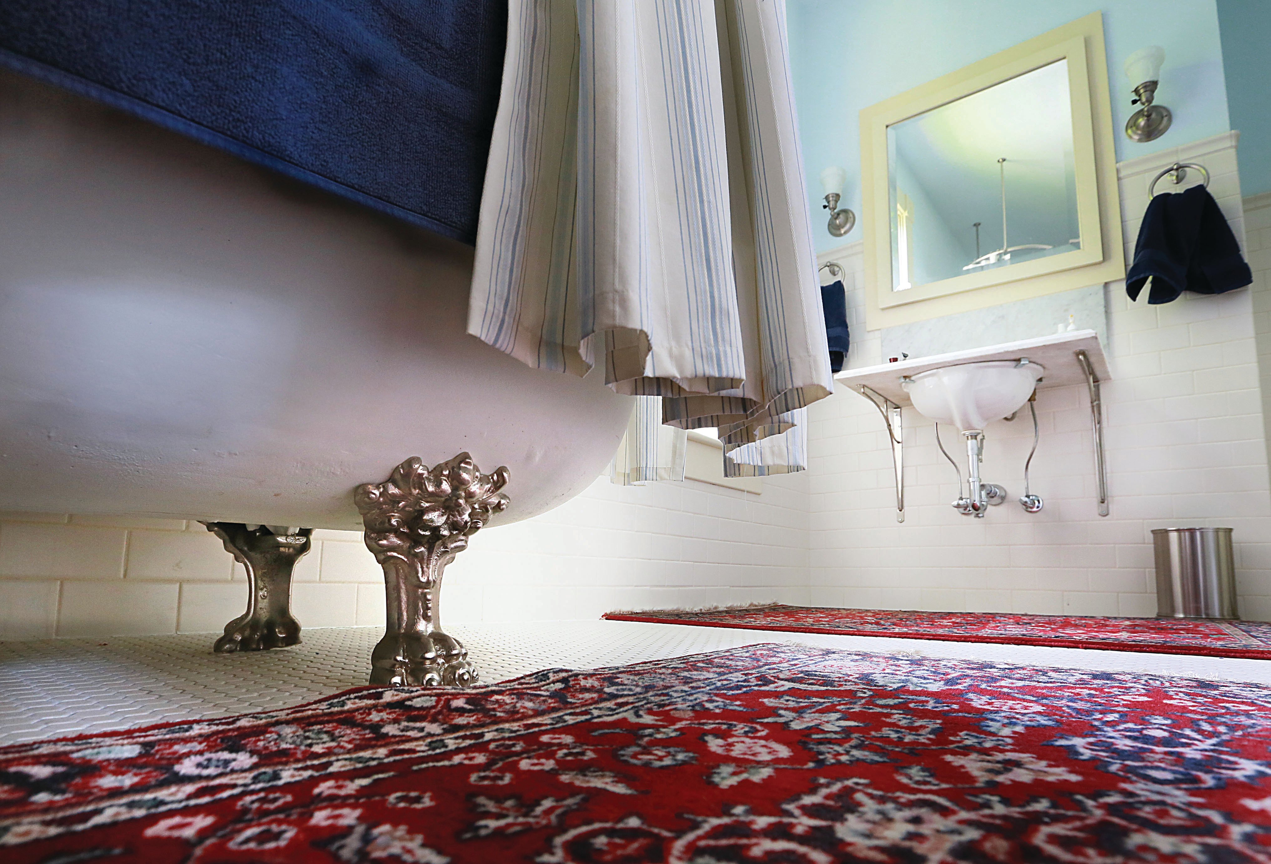 vintage bath with clawfoot tub and subway tile