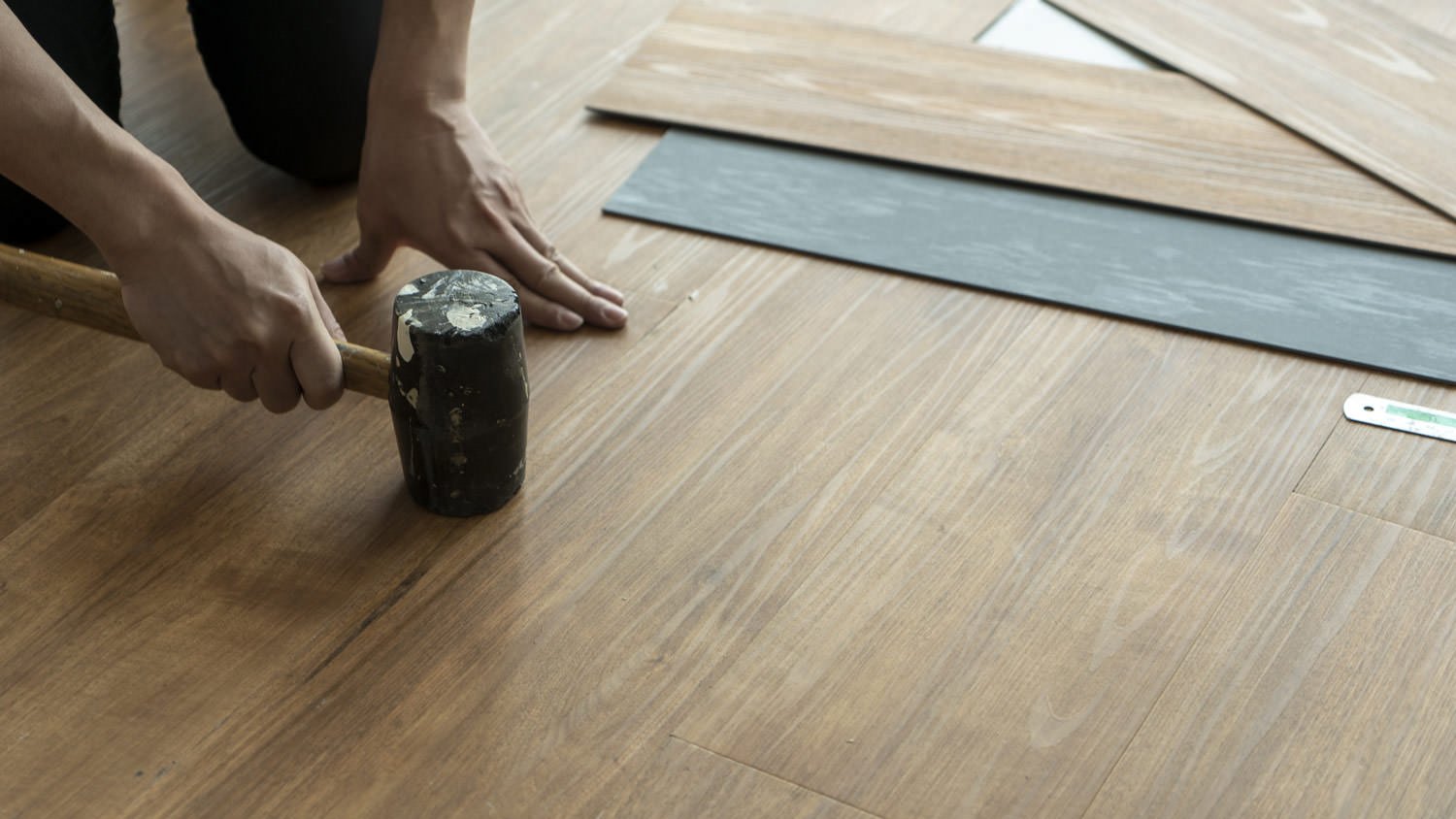 Professional installing luxurious vinyl flooring