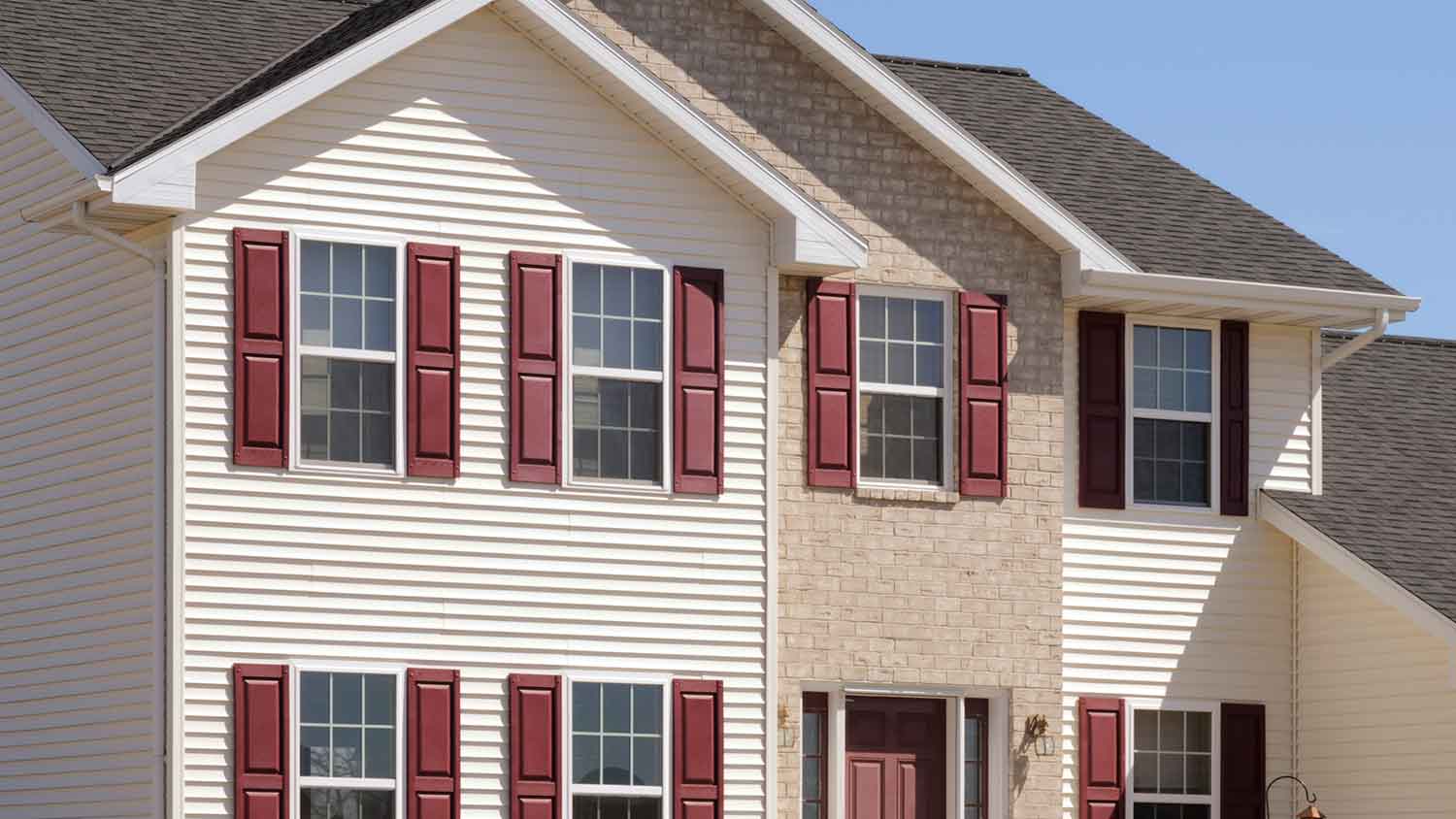 House exterior with red vinyl window shutters