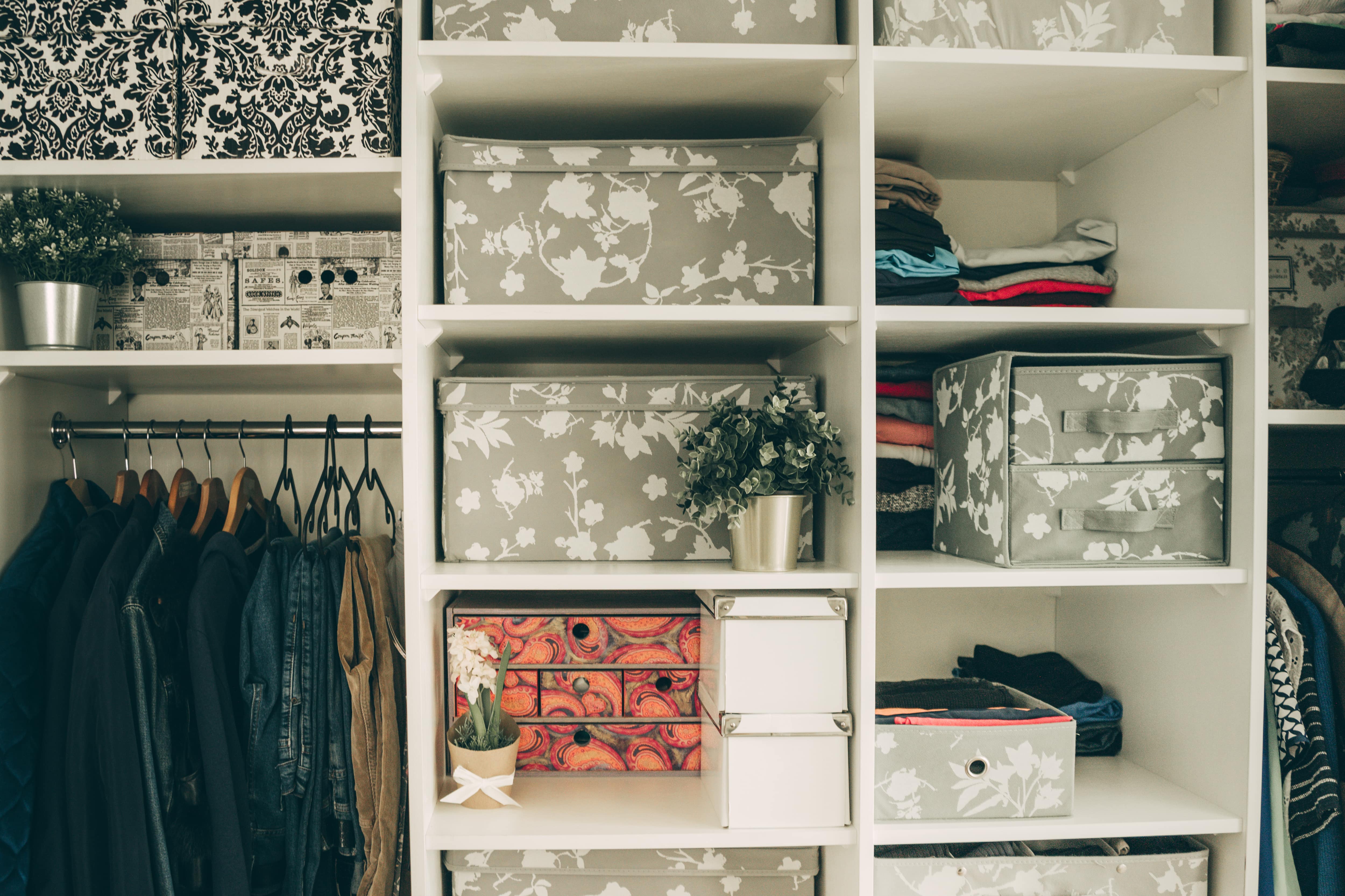 A close up of closet shelves with multiple cloth baskets for storage