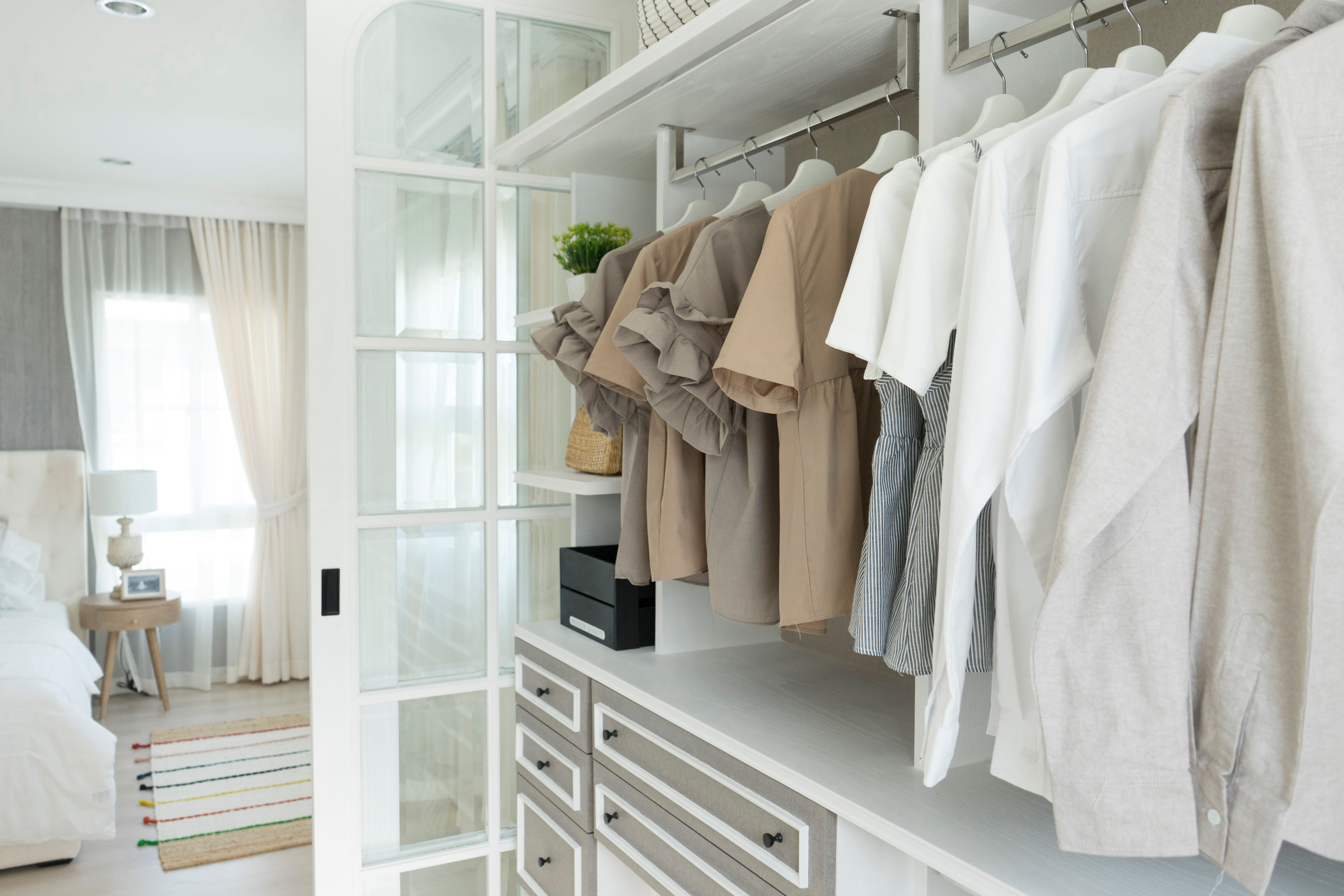 A white walk-in closet with French style glass doors