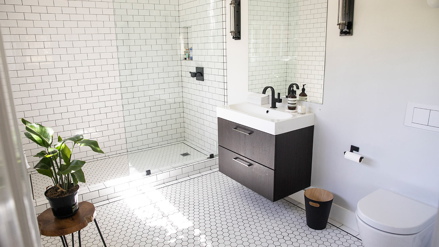 A bright and airy luxury bathroom with subway tile walk-in shower