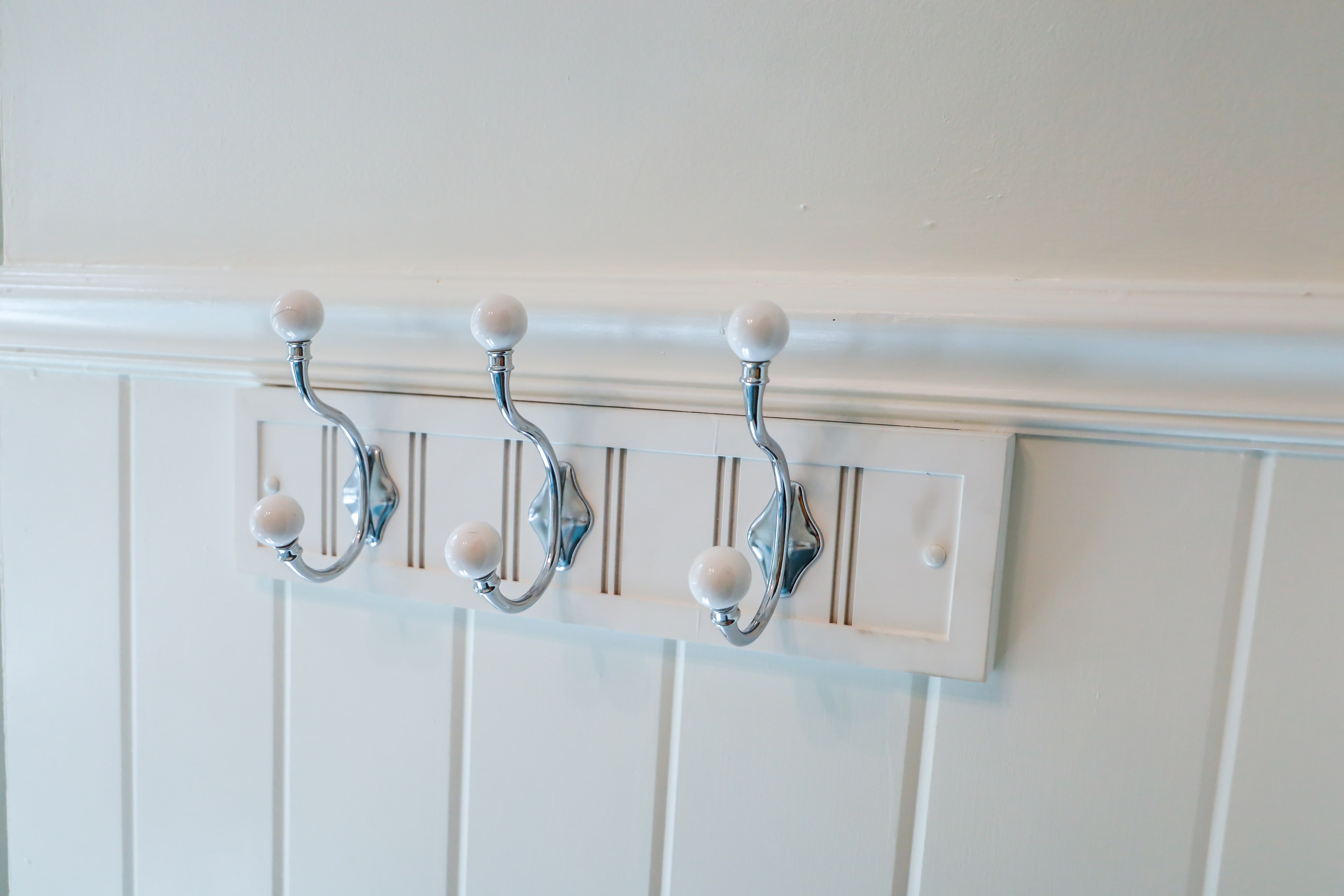 Beadboard installed in bathroom with towel hooks