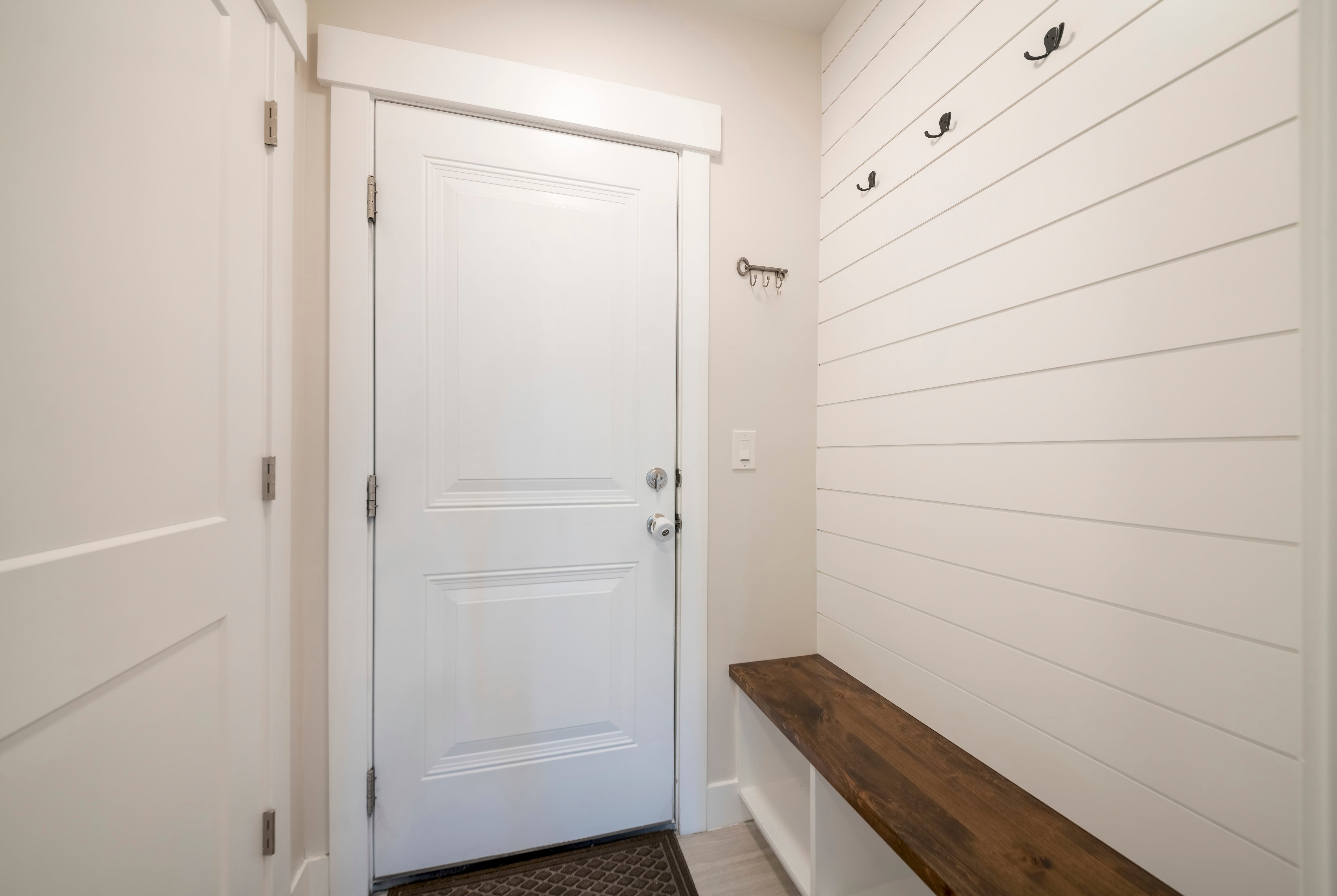 Shiplap planks wall covering in mudroom