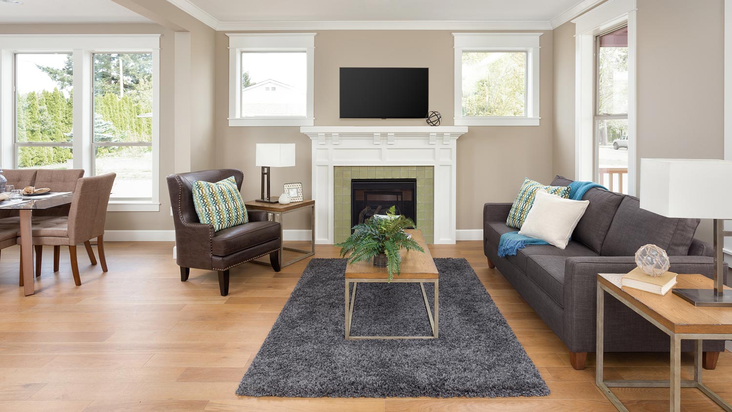 TV mounted on wall in open concept living and dining room