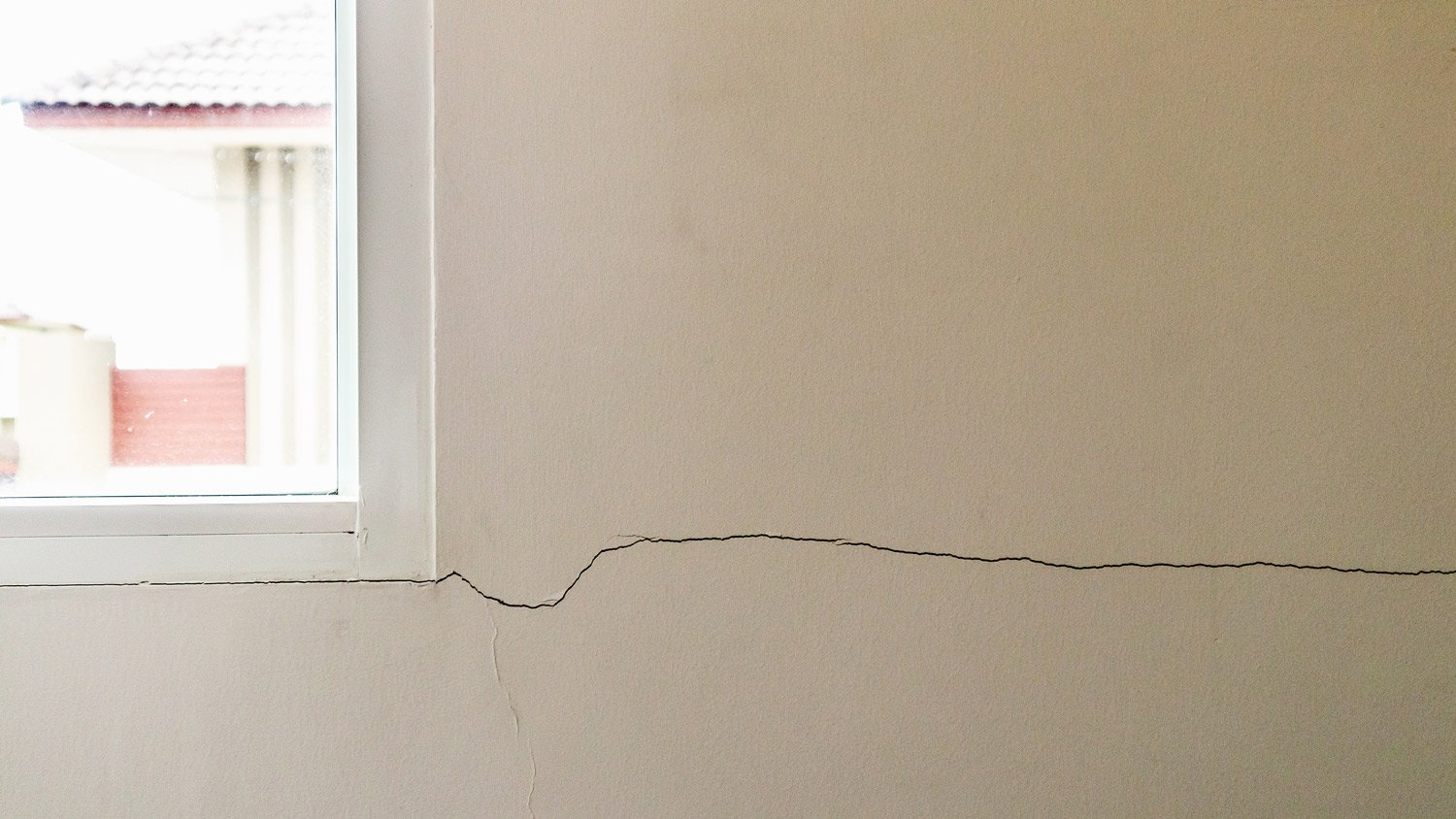 New house wall crack near window frame