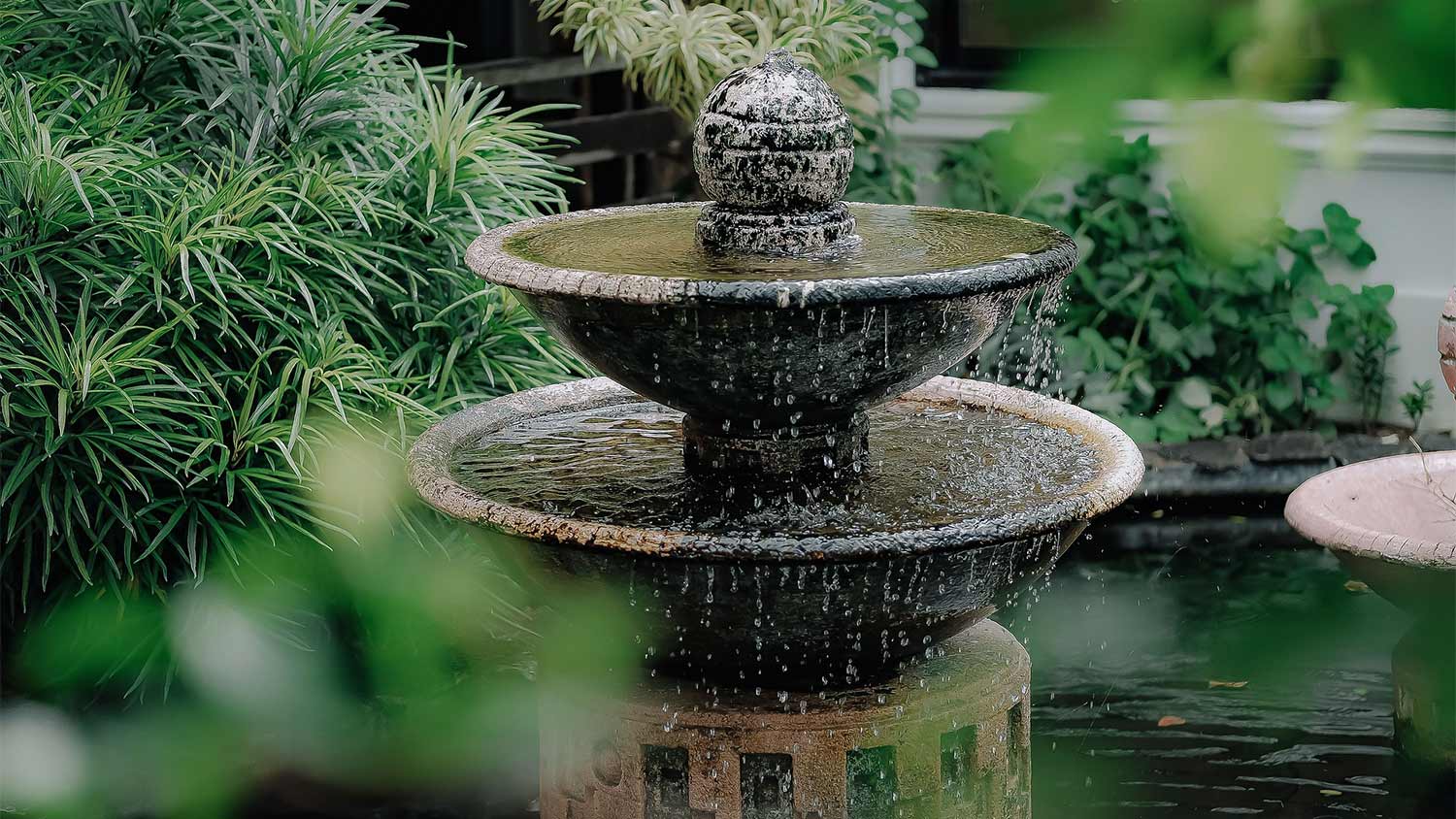 A fountain with water running into a pool