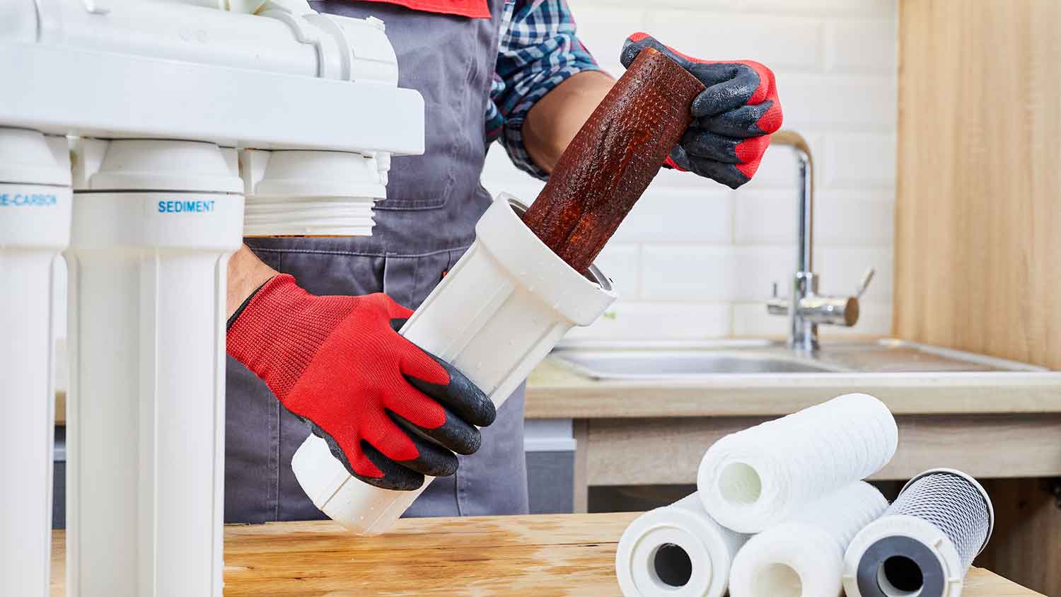 Technician changing water system filter  