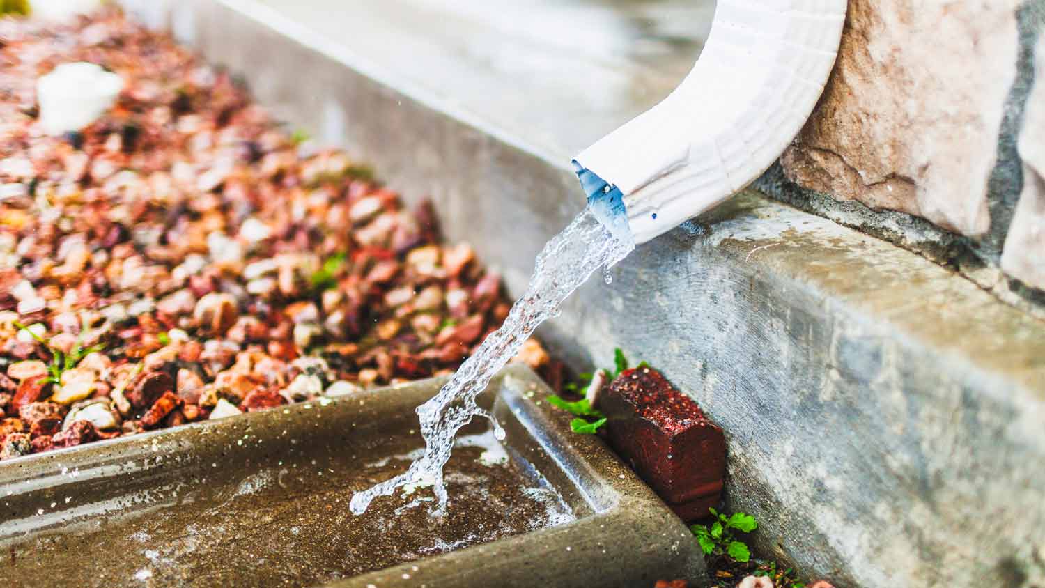 water flowing in downspout