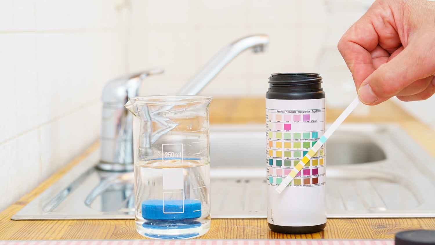 Using test kit to check tap water quality