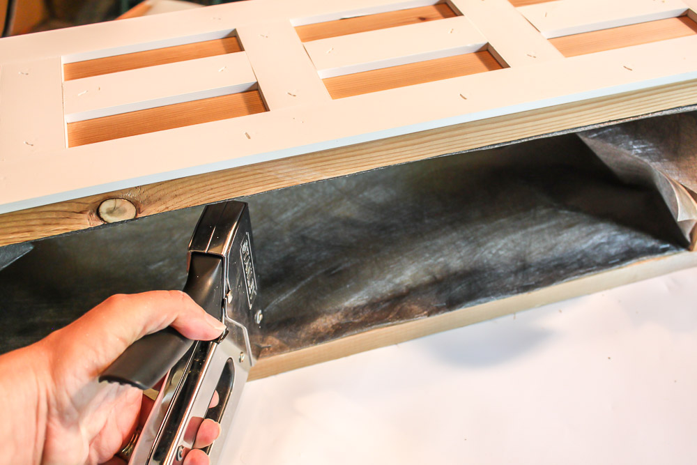 stapling weed block fabric to inside of window box