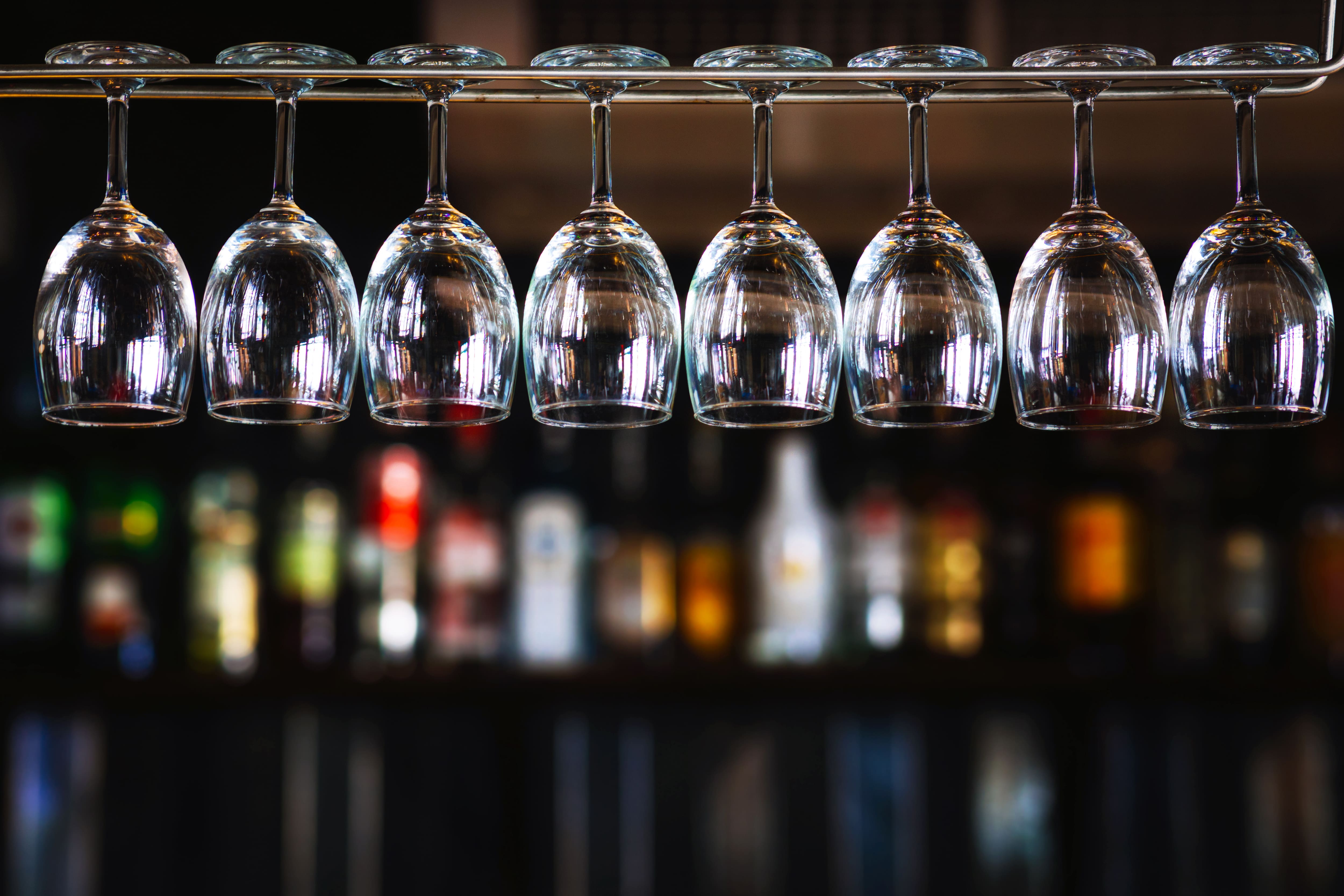 Wine glasses hanging above a wet bar 