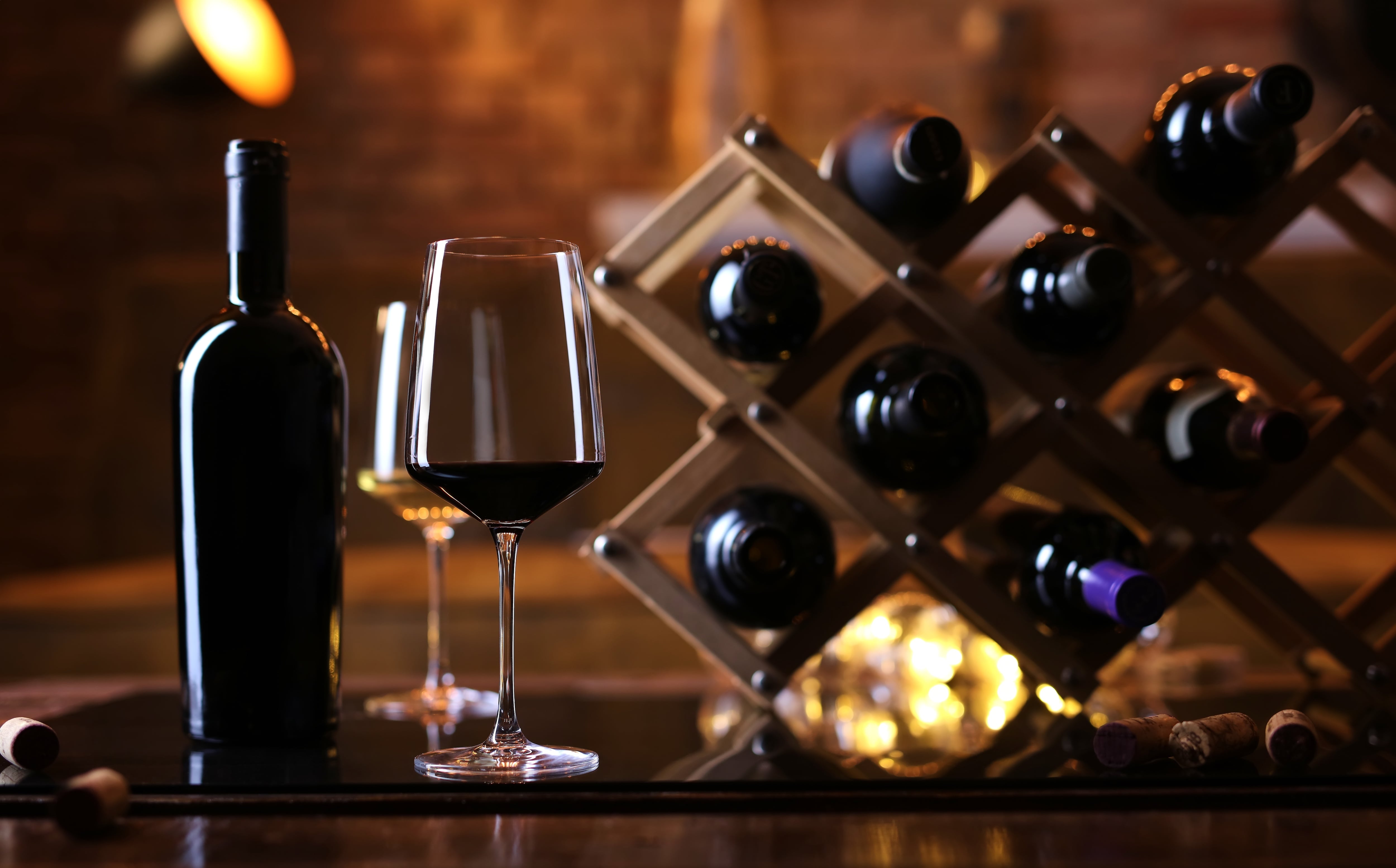 Tabletop wine rack with wine bottles and glasses 