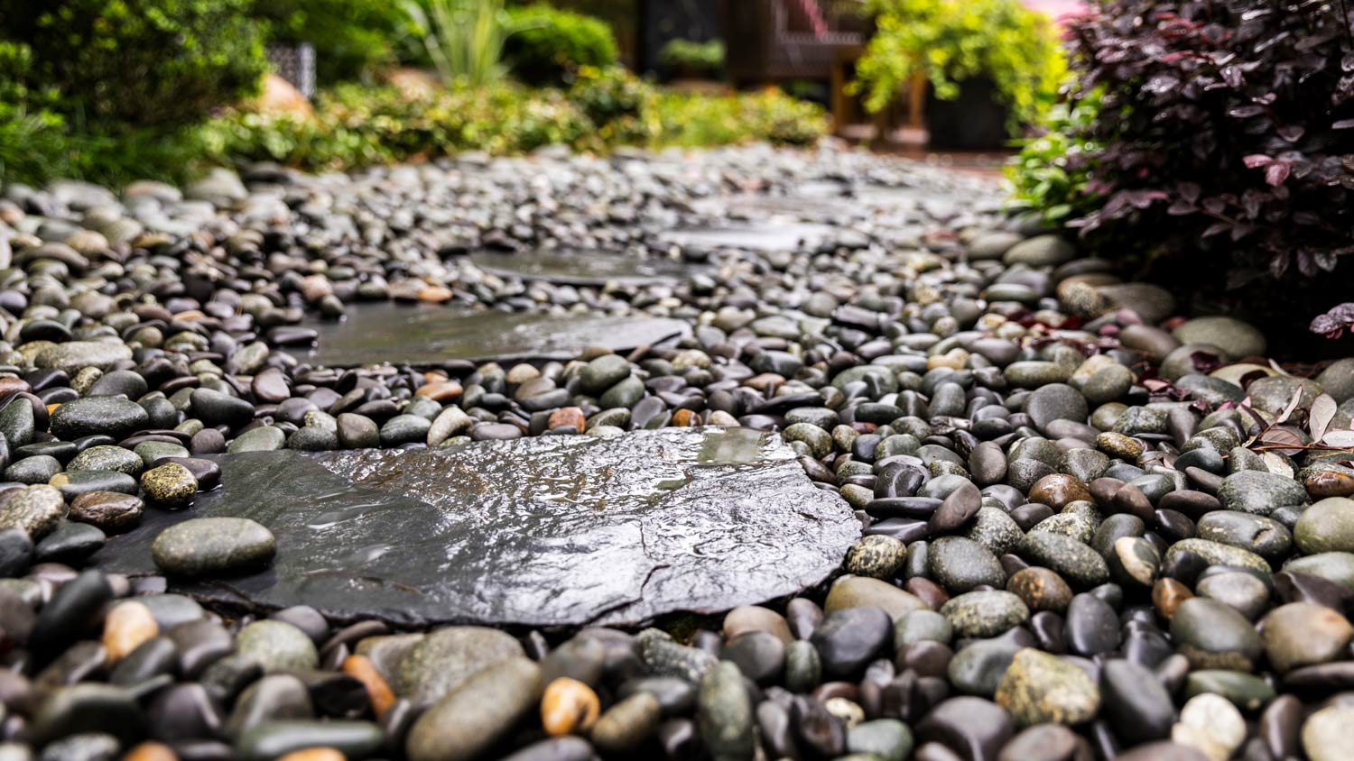 Decorative sprinkling of flowerbed paths with pebbles