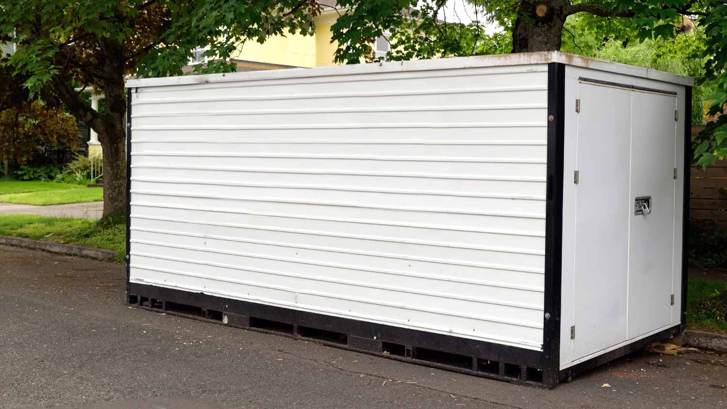 white storage container on residential street