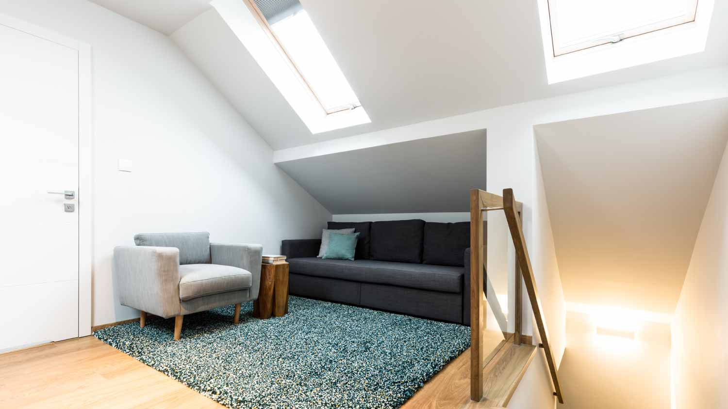 White attic house interior with roof windows