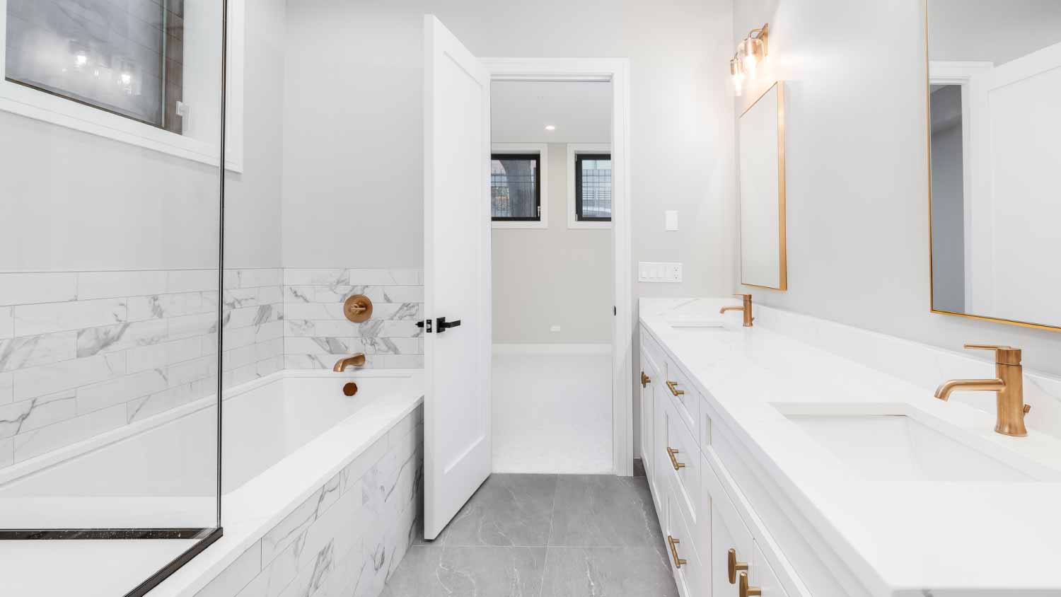 White bathroom with gold hardware and faucets