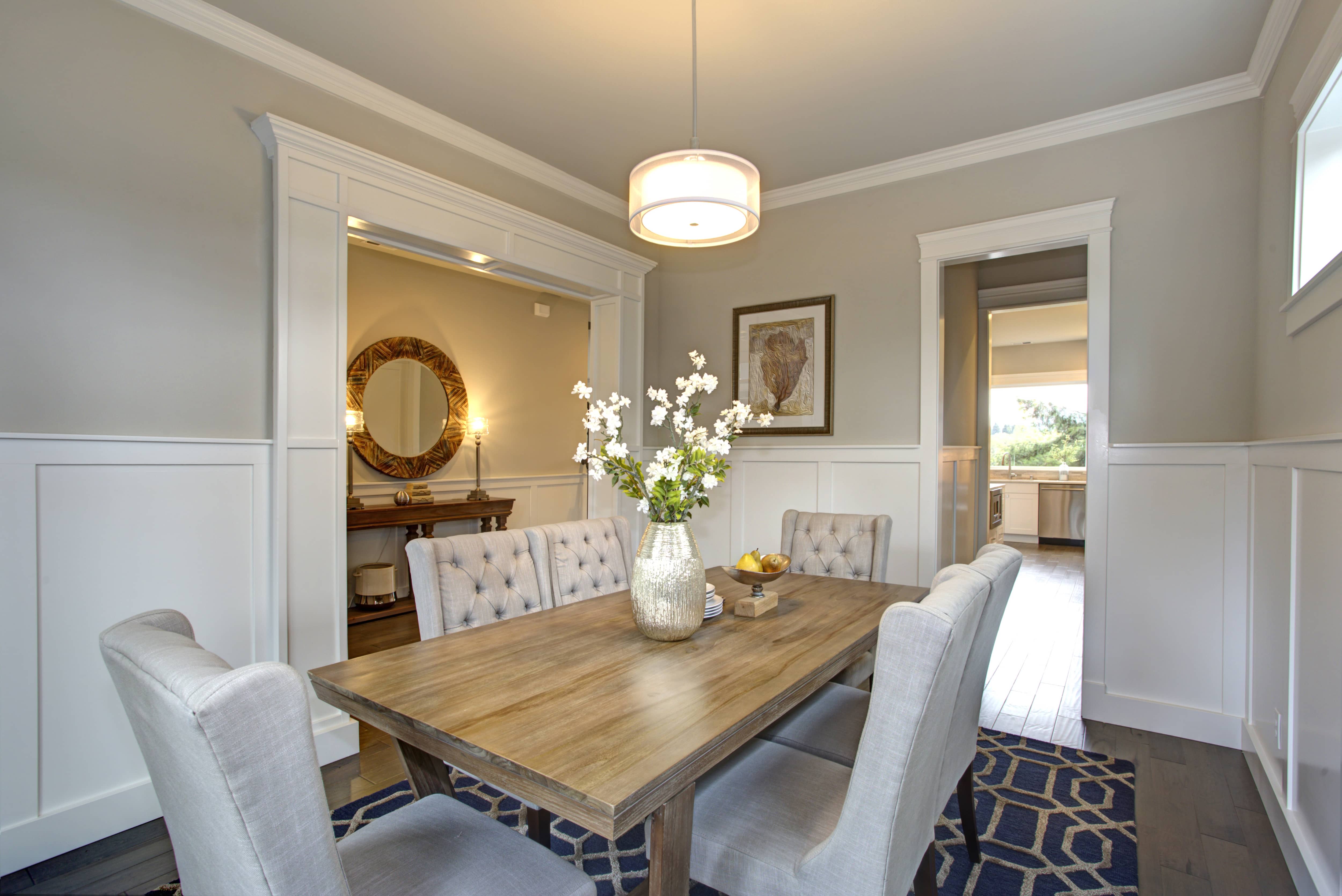 Dining room with white board and batten, white trim, and gray walls