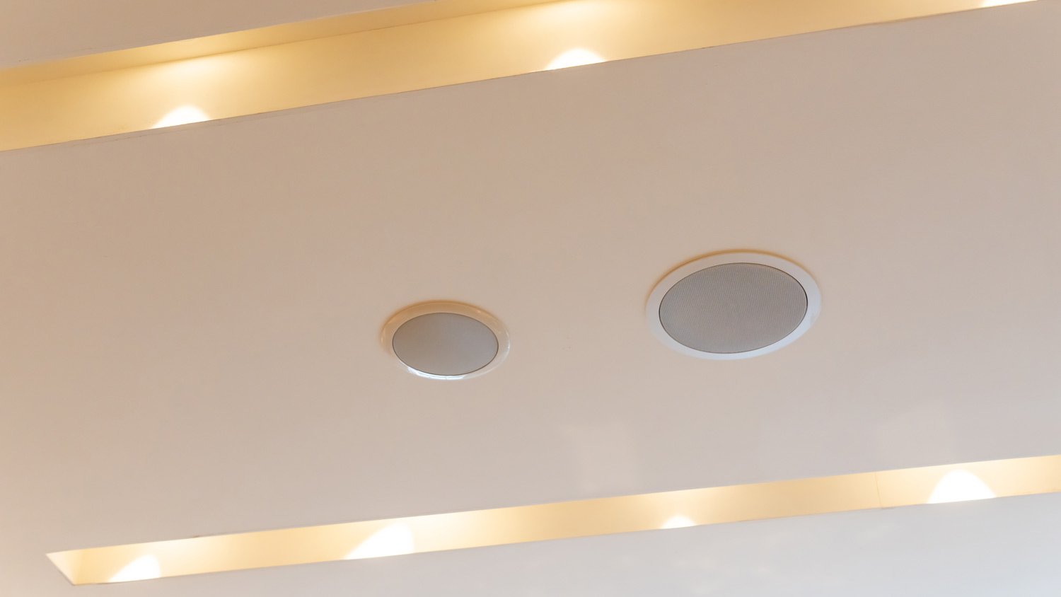 close up of white ceiling speakers