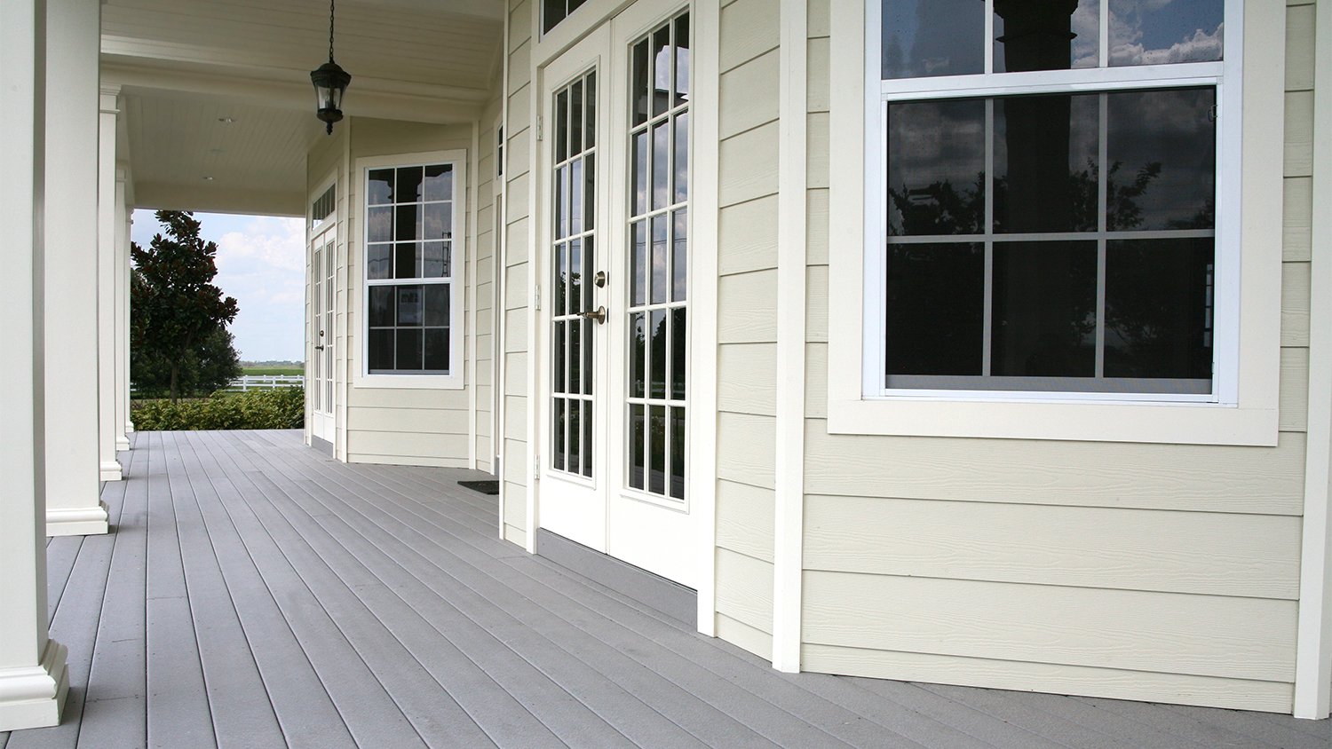 A white front porch with french doors and windows