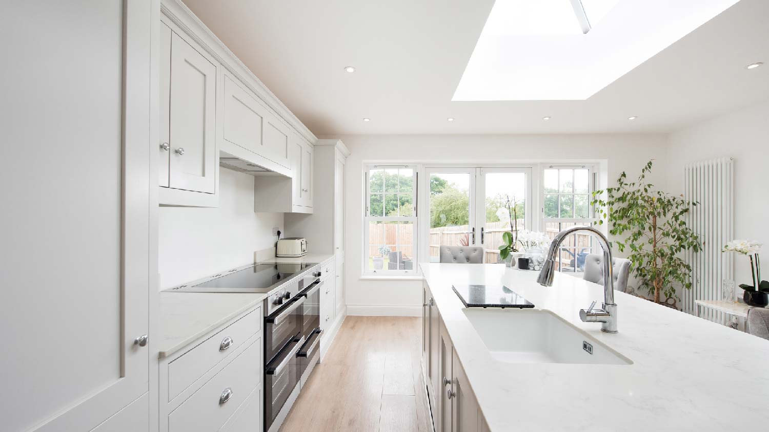 A white kitchen with a solid surface countertop