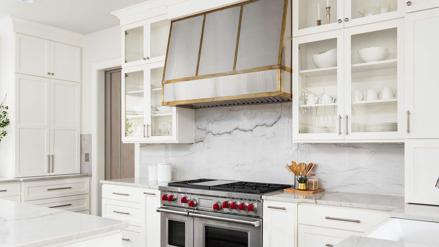 white kitchen with steel and gold range